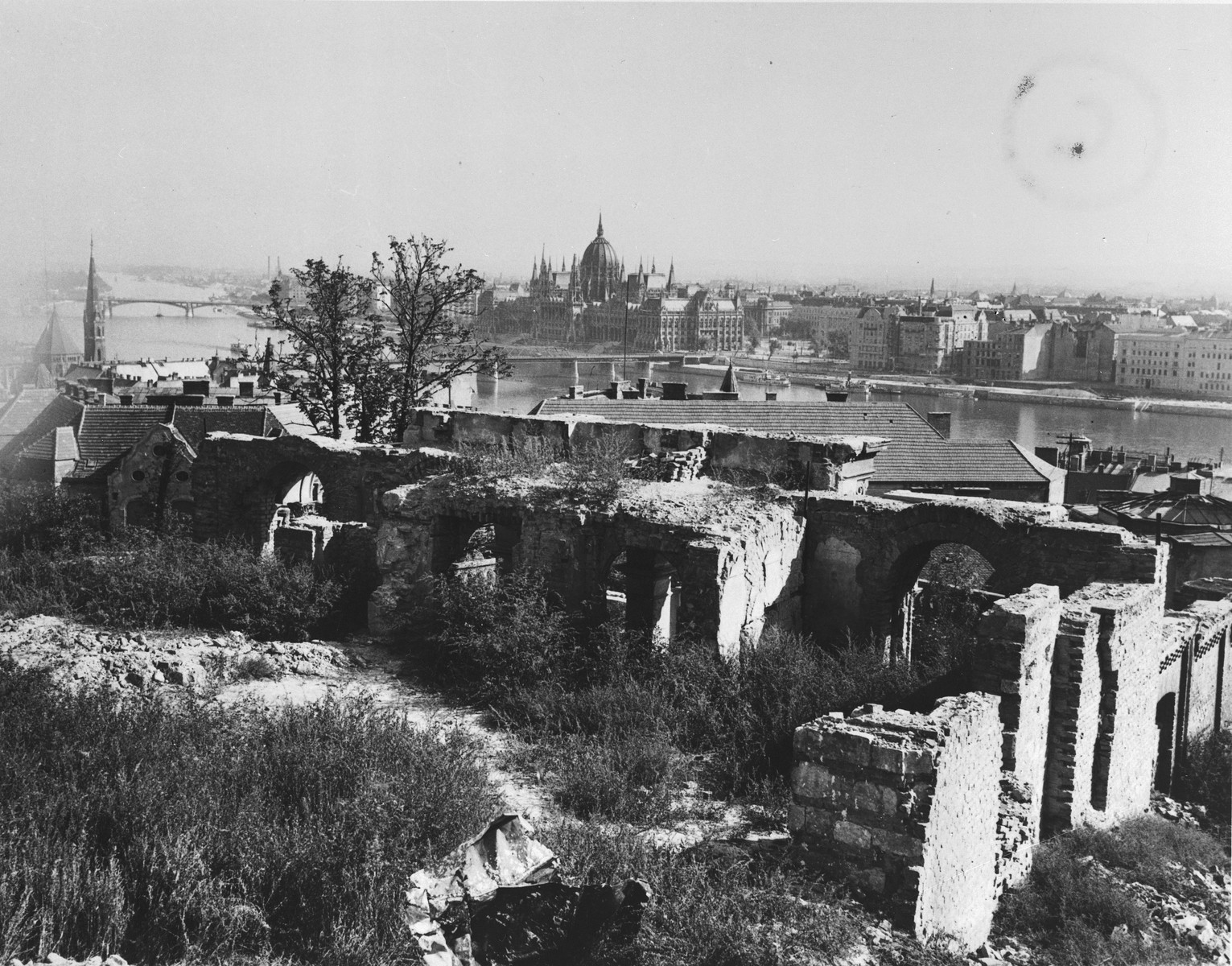 View of the Kossuth Bridge spanning the Danube River in Budapest. 

In the foreground are the ruins of the foreign ministry in Buda.  In the background on the far side of the river is Pest.  The Margaret Bridge may be seen in the distance, in the upper left.  The photo was taken from the site of the British Legation in Buda.