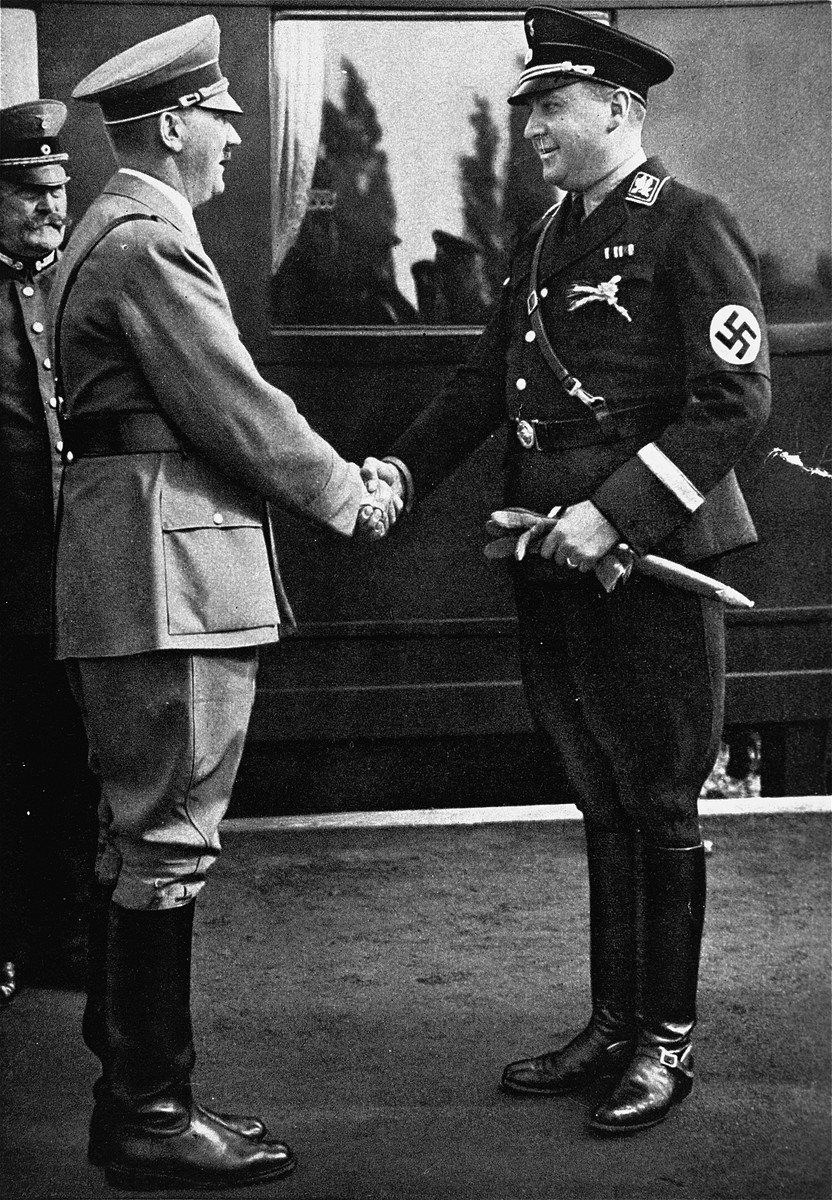 Reich Minister Richard Walther Darre greets Hitler at the train station at the time of the harvest festival.

[Joe White has also identified this Nazi official as Kurt Daluege (Chief of the Ordnungspolizei)]