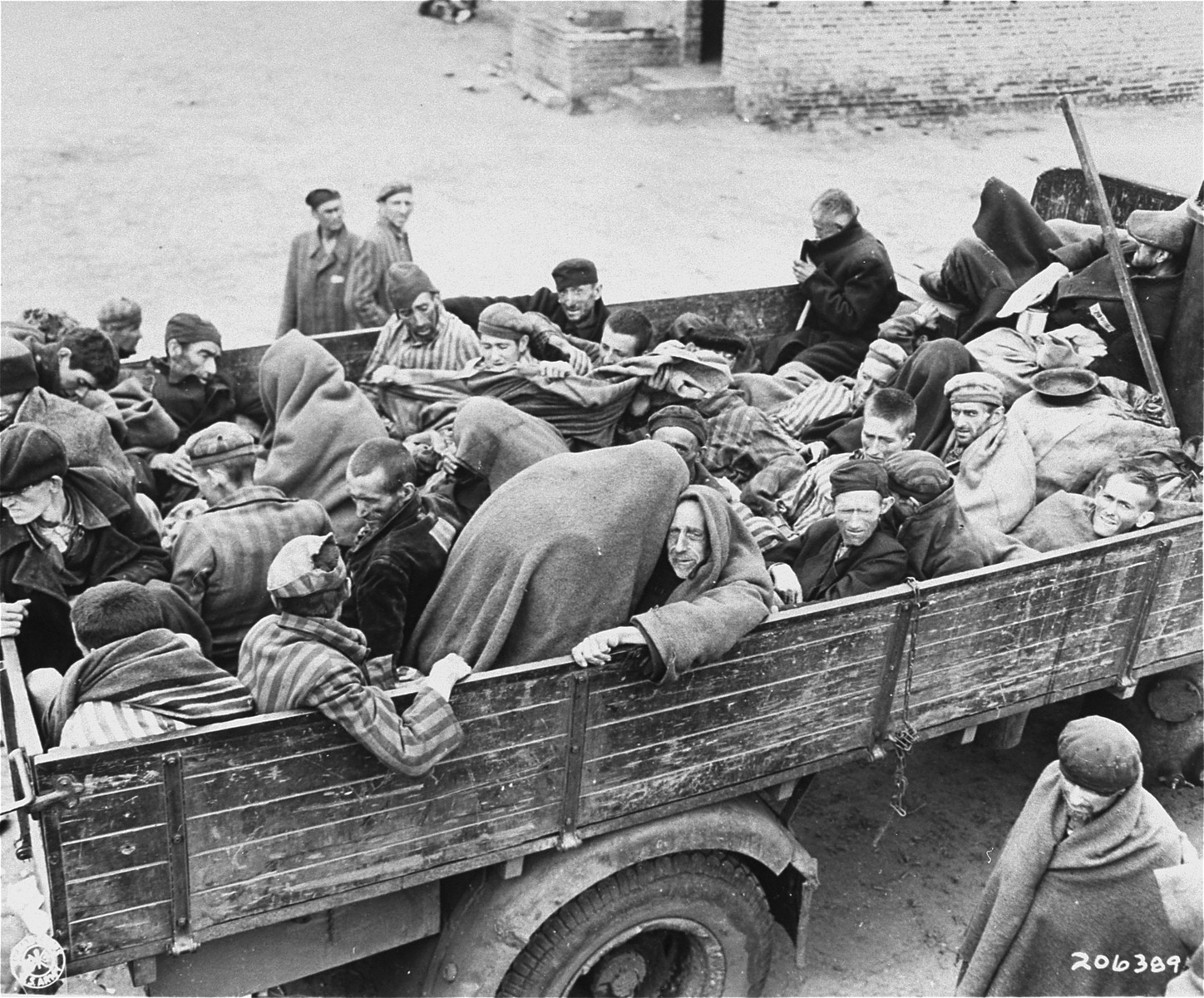 Survivors from the Woebbelin concentration camp are evacuated from their barracks to a nearby field hospital where they will receive medical attention.