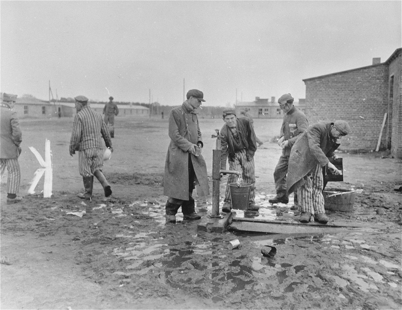 Survivors get water at one of the community pumps in the newly liberated Woebbelin concentration camp.