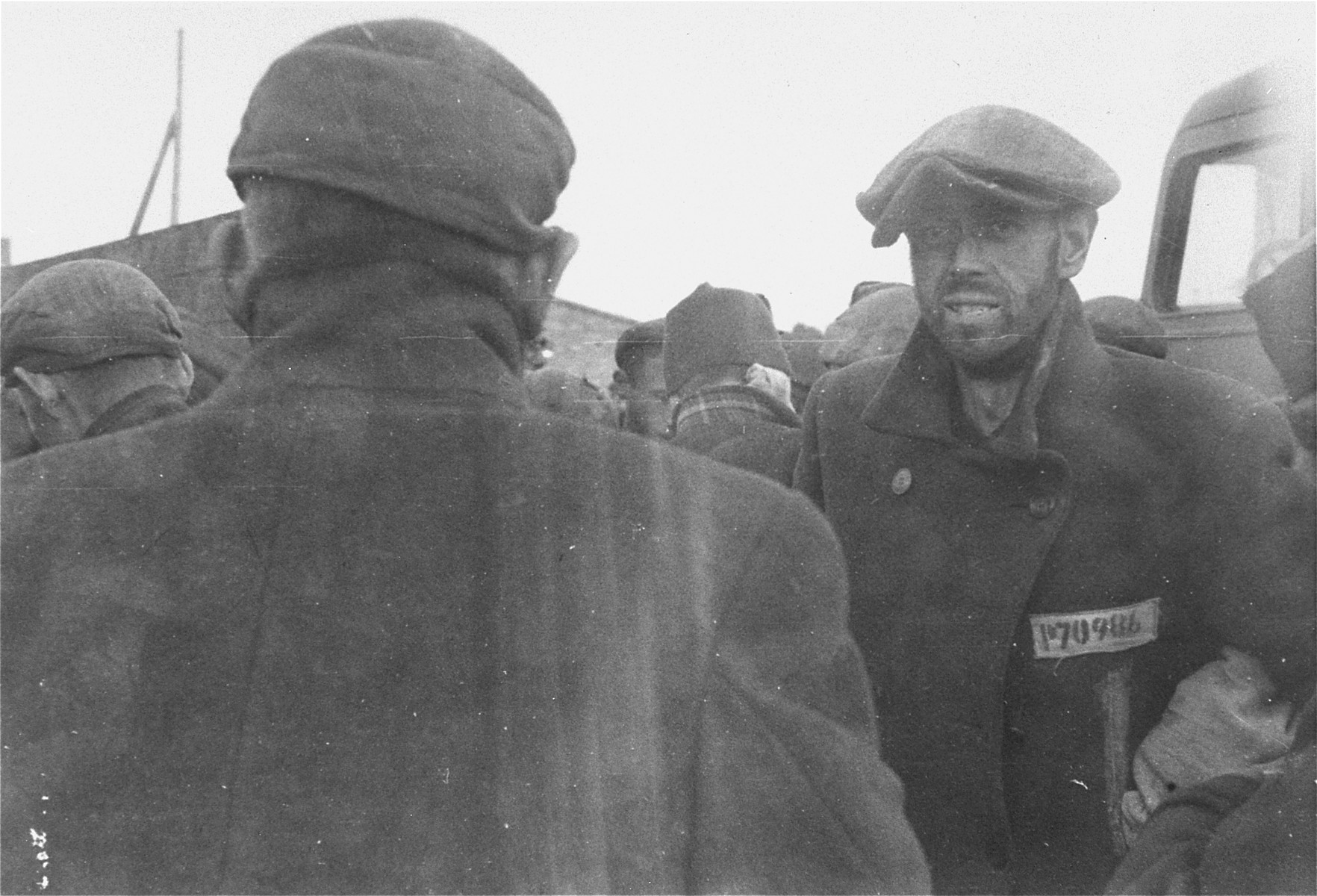 Survivors in Woebbelin wait to be evacuated to an American field hospital for medical attention.