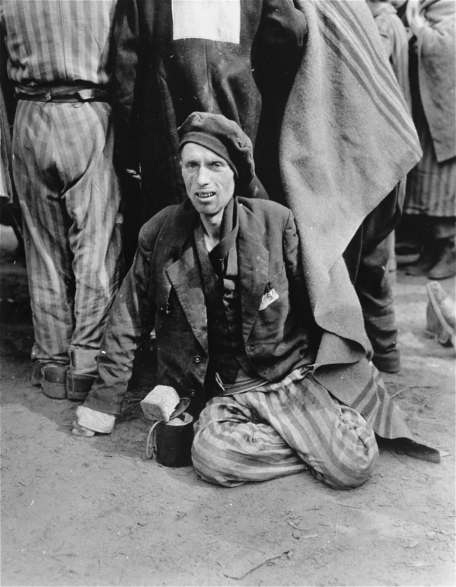 An emaciated survivor waits for evacuation from the Woebbelin concentration camp to an American field hospital.