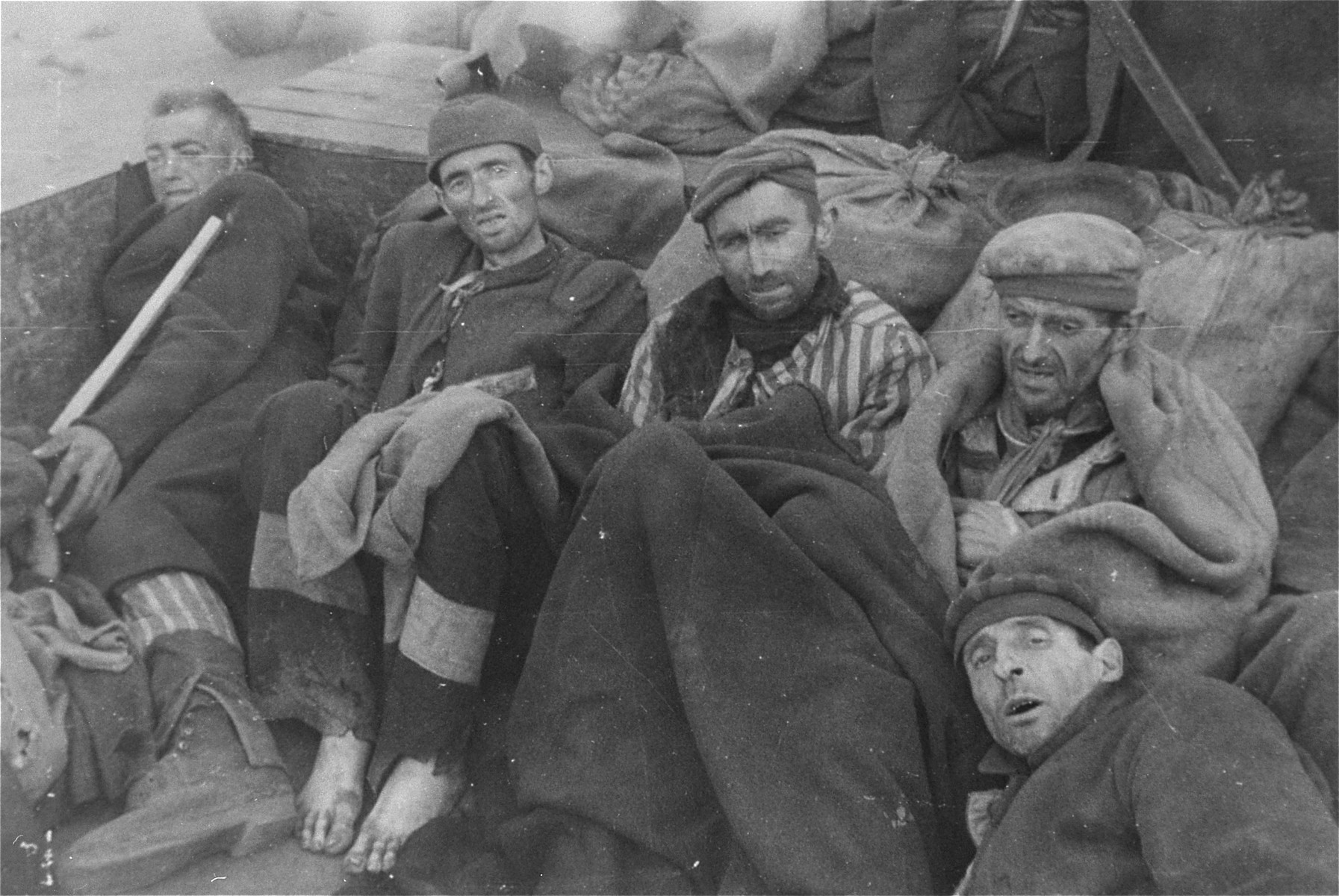 Survivors in Woebbelin wait for evacuation to an American field hospital, where they will receive medical attention.