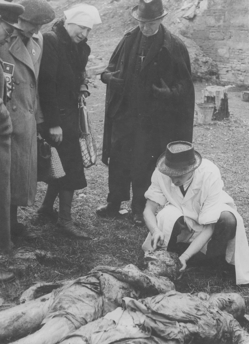 Hungarian civilians identify the corpses of Jews exhumed from a mass grave.  The victims were killed in the Maros Street Hospital massacre.

The woman in the head scarf is Iren Kaufmann.  She is identifying the remains of her husband Zsigmond Kauffmann, who was a veterinary surgeaon and was a patient at the Maros utca hospital.  Standing beside her is her sister-in-law (Zsigmond's sister), Dr Iren Weisz. .