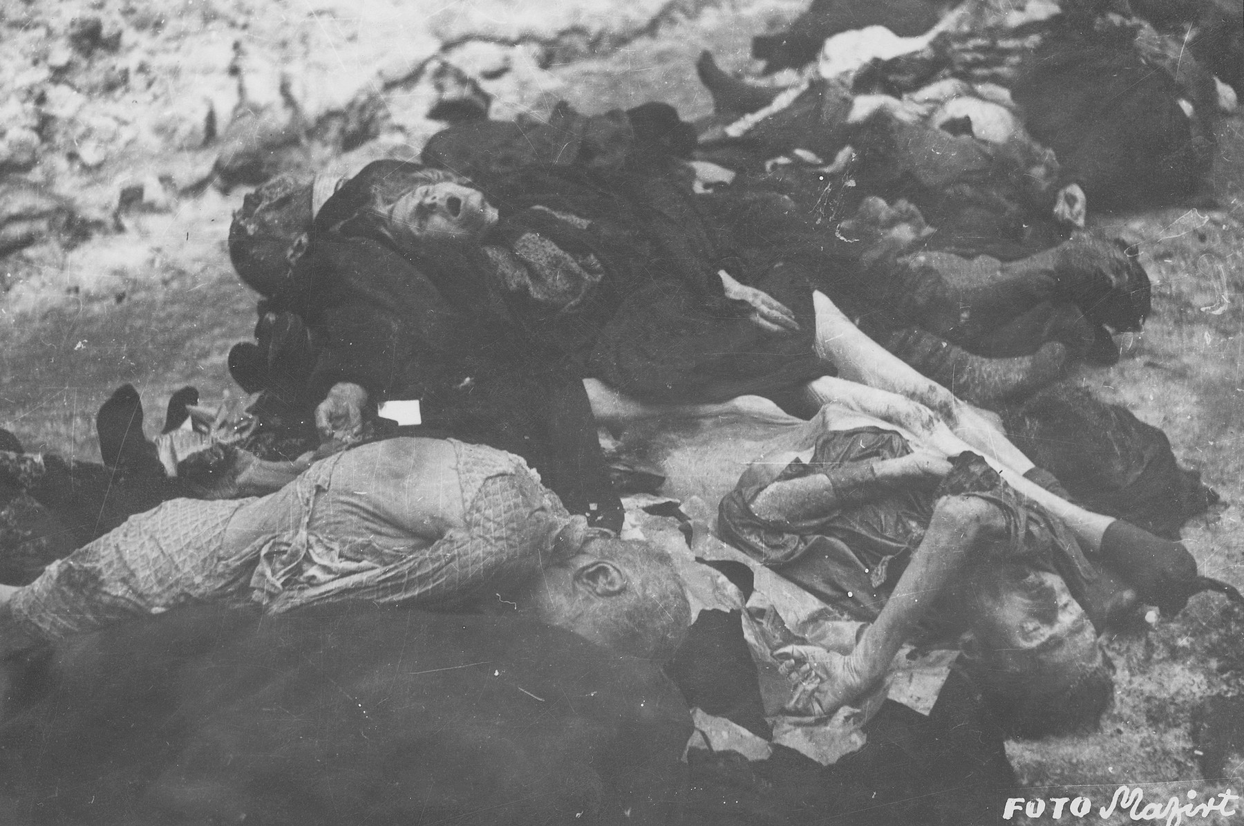 The corpses of Jews in the courtyard of the Dohany Street Synagogue.

During the last few months of the war in Hungary, the Nyilas (Arrow Cross) exploited the anarchic conditions in the areas still under their control to continue their excesses against the Jews.  This was particularly true in Budapest, despite the fact that the Soviet army had completely encircled the city by December 27, 1944.  The reign of terror that had begun with Szalaszi's assumption of power on October 15, 1944, went almost completely unchecked after the beginning of the Soviet siege on December 9.  Gangs of armed Nyilas--mostly teenagers--roamed the city hunting for Jews in hiding.  They searched them out in hospitals, shelters, homes outside the ghetto, in the International Ghetto, and in the large ghetto.  After robbing the Jews of their remaining valuables, the Nyilas shot them on the spot or marched them to the banks of the Danube, where they shot them, and threw their bodies into the river.  A large number of Jews who were murdered in the ghetto were buried in mass graves in the courtyard of the Dohany Street Synagogue.

The most horrific of these attacks occurred on the Pest side of the capital, at the two Jewish hospitals located on Maros and Varosmajor streets.  The Maros Street hospital, which had operated under the protection of the International Red Cross during the German occupation, was attacked on January 11, 1945.  After the initial melee, during which Nyilas gang members wantonly destroyed hospital equipment, threw patients out of their beds and trampled them, and murdered staff members, survivors were ordered to dig a mass grave, remove and bury the bodies.  They were then shot and buried in the grave themselves.  Only one nurse survived of the 92 people that were in the hospital at the time.  Three days later, on January 14, the hospital on Varosmajor Street was attacked, resulting in the deaths of 150 patients and medical staff.  These manhunts and massacres continued unabated until the liberation of Budapest in April.  [R. Braham, "The Politics of Genocide," vol. 2: 995-1007]