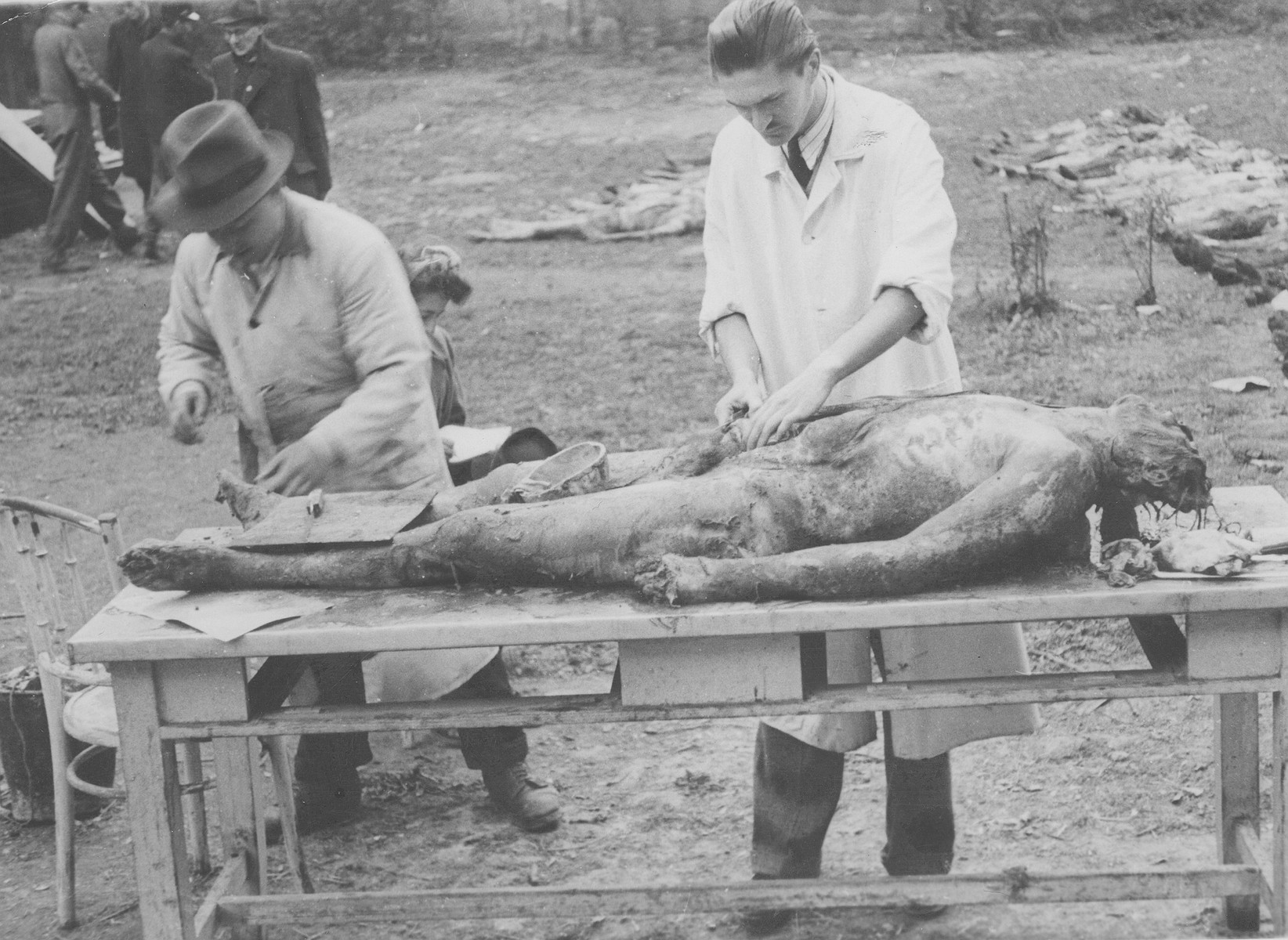 Members of the Commission for the Investigation of Nazi and Arrow Cross Atrocities perform an autopsy on one of the corpses exhumed from a mass grave.  The victim is one of the many Jews killed in the Maros Street Hospital massacre.