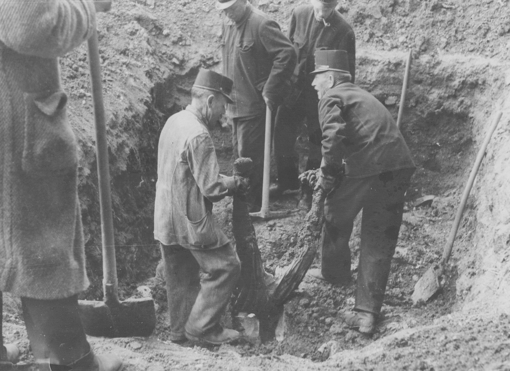 Hungarian gendarmes exhume the bodies of Jews from a mass grave.  The victims were killed in the Maros Street Hospital massacre.