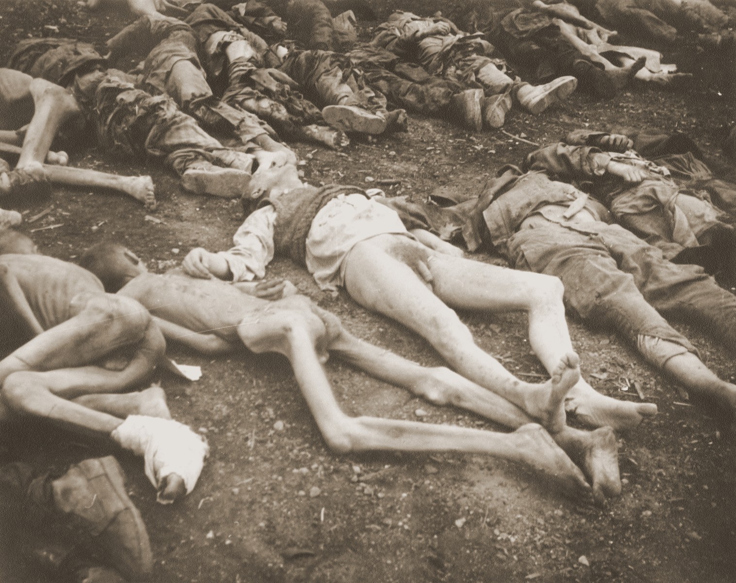 The bodies of prisoners killed in the Nordhausen concentration camp, which have been laid out in long rows outside the central barracks (Boelke Kaserne).