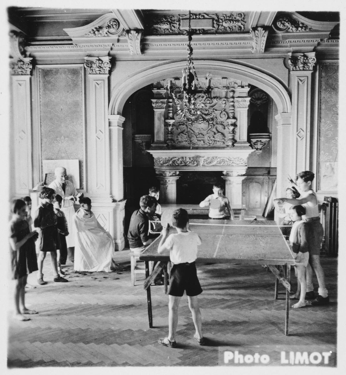 Children play ping pong in a large hall in the Mehoncourt children's home.