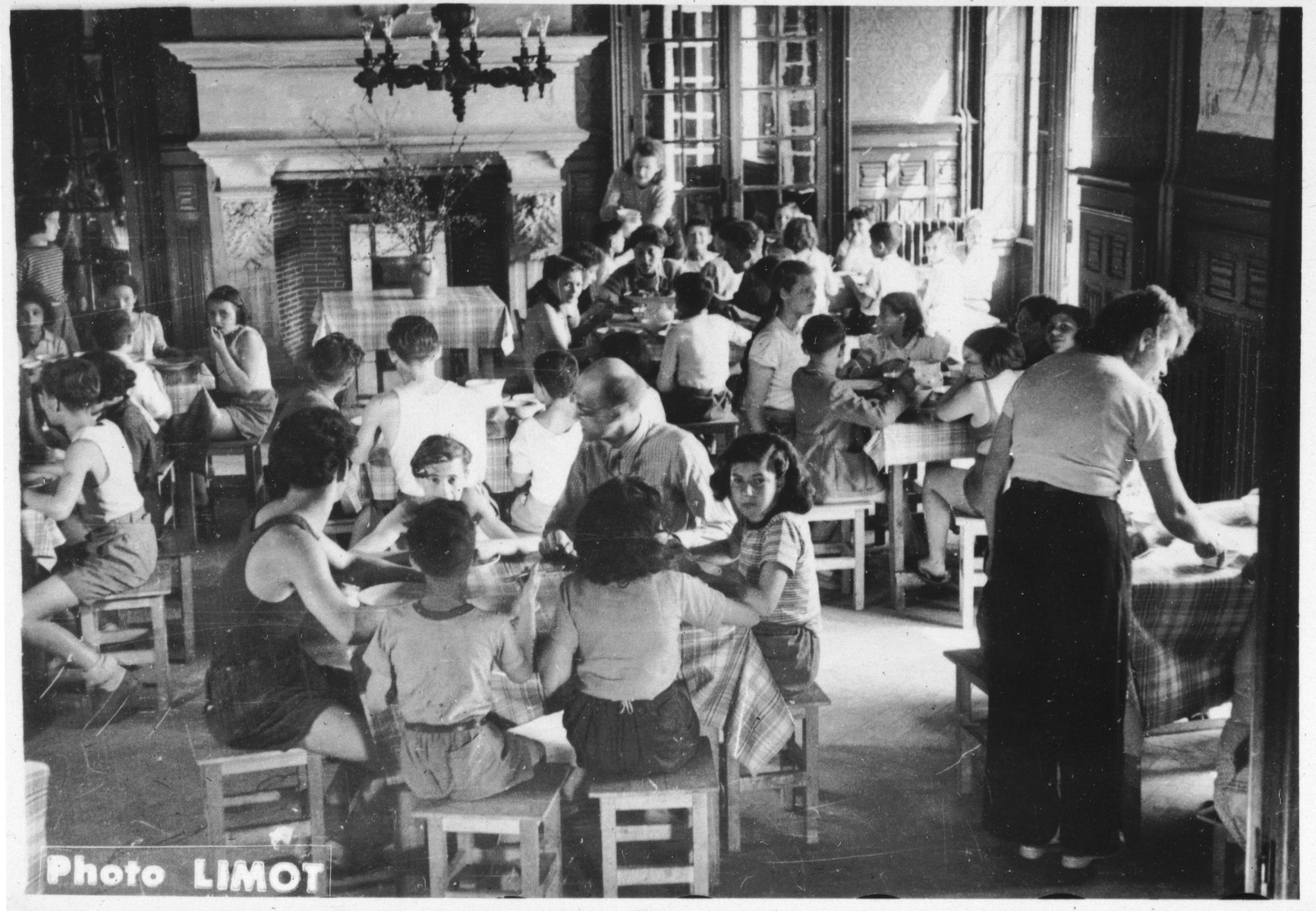 Children and counselors gather for a meal in the dining room of the Mehoncourt children's home.