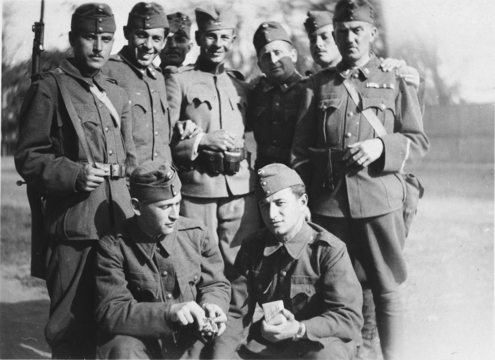 Group portrait of former Jewish soldiers now conscripted into a Hungarian forced labor battalion.

Jeno Lebowiz is pictured in the front, right corner.