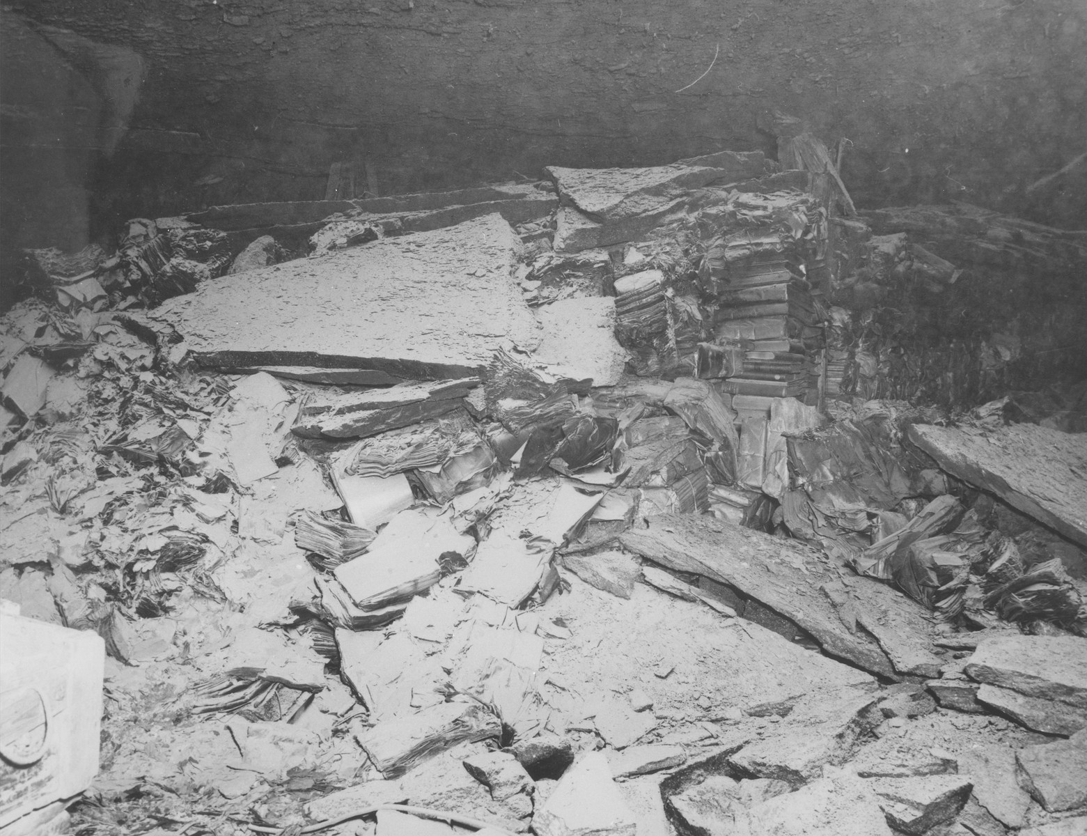 View of the charred remains of books from libraries in Berlin and Marburg that had been stored in a salt mine near Heimboldshausen, Germany.  

According to American military sources, the books were burned in the salt mines by displaced persons.