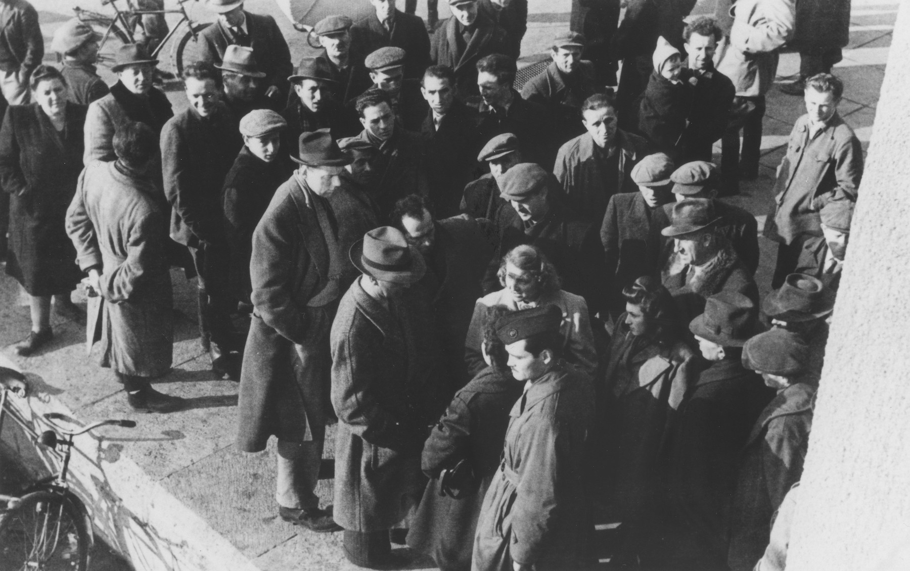 Jewish DPs gather in a central square of the Eschwege displaced persons camp following a raid by American military police searching for contraband.