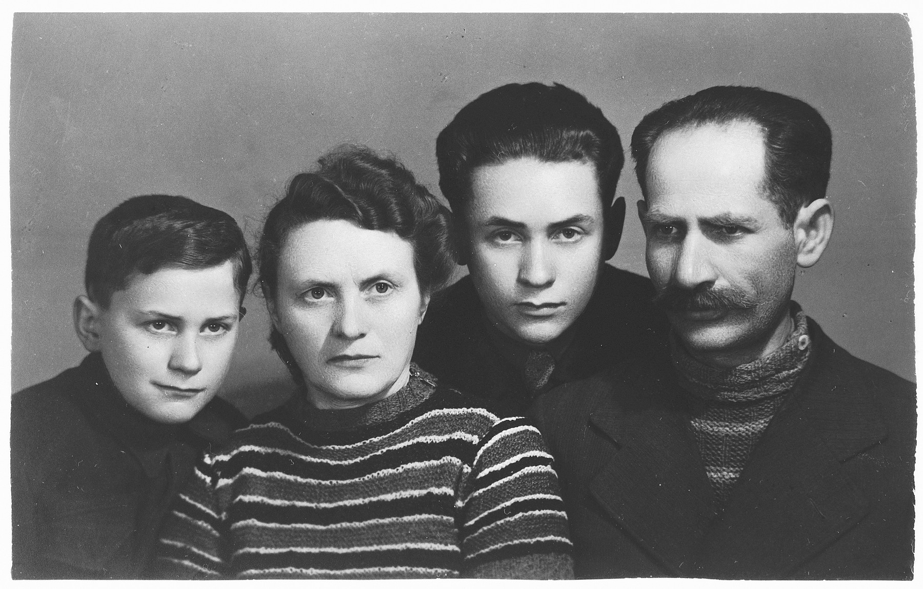 Studio portrait of a family of Polish Jewish survivors in Krakow, Poland.

Pictured are Isaac and Ida Friedberg and their two children, Maurice (second from the right) and Shimon (left).