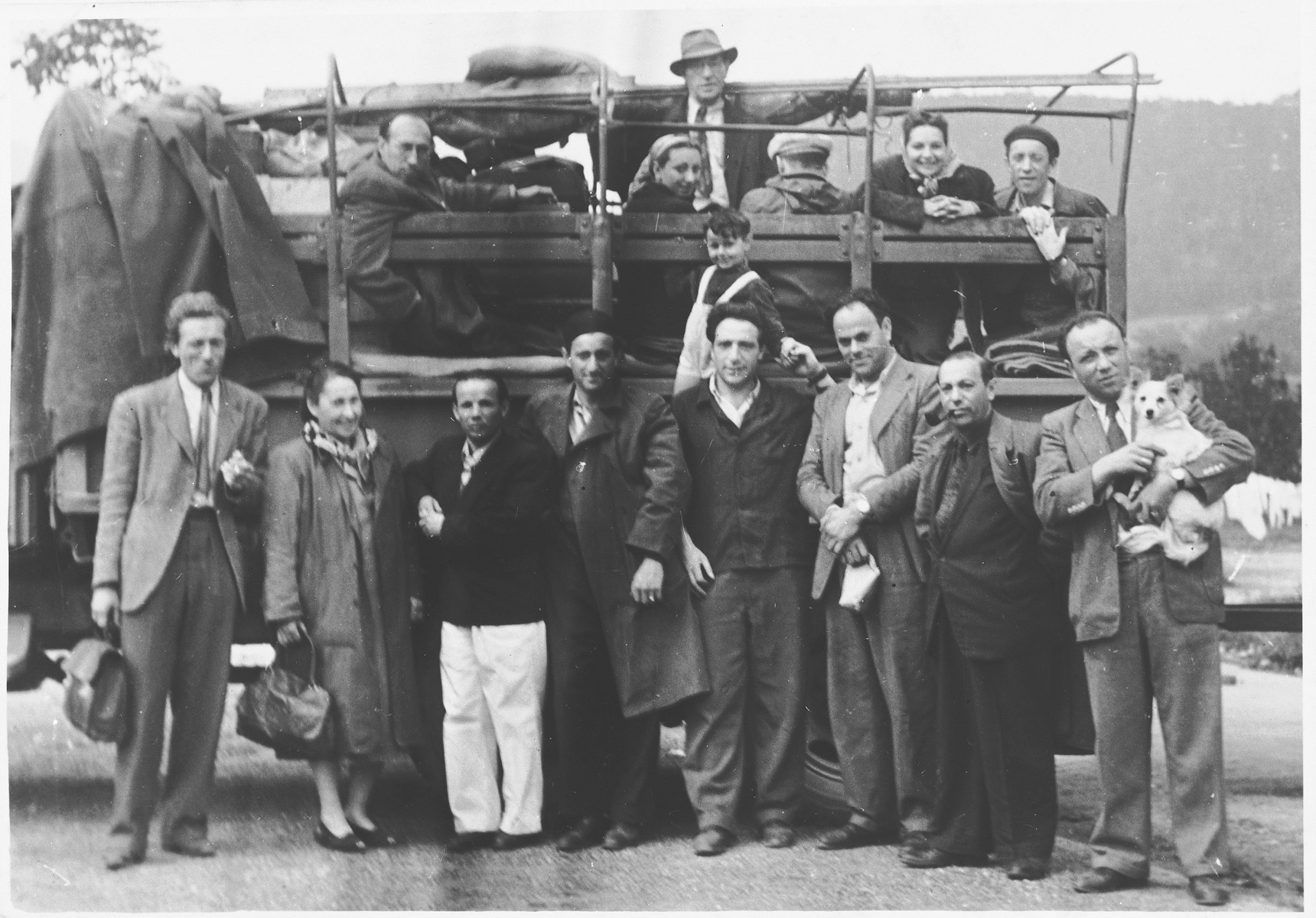 Jewish DPs gather in front of and inside an open truck in the Landsberg DP camp.