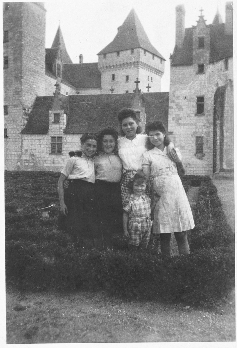 A group of girls of varying ages poses together outside the Le Coudray ...