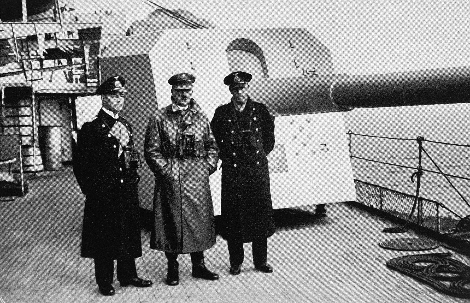 Hitler inspects a German naval warship [perhaps the Deutschland]. 

To his left is Admiral Erich Raeder.  On the right is most probably,  Captain Hermann v. Fischel, commander of the Deutschland from 01 Apr 1933 to 29 Dec 1935.