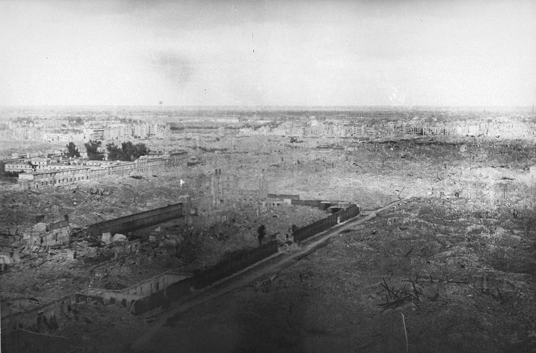 View of the ruins of the Warsaw ghetto.  

Pictured in the middle are the walls of the Pawiak prison.  Visible on the far left is the Gesiowka prison.