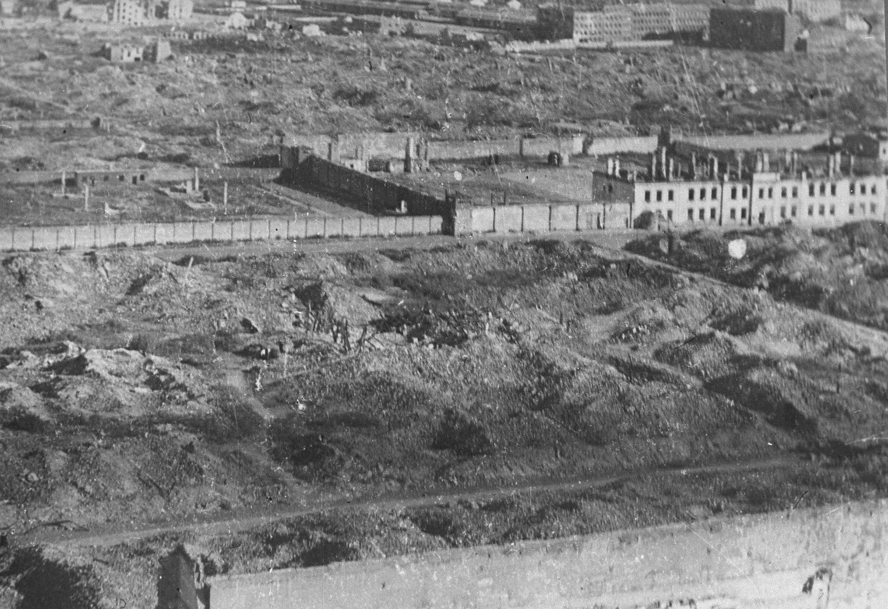 View of the ruins of the Warsaw ghetto.  

Pictured in the foreground are part of the wall of Pawiak prison and ruins of buildings and warehouses on Stawki Street.