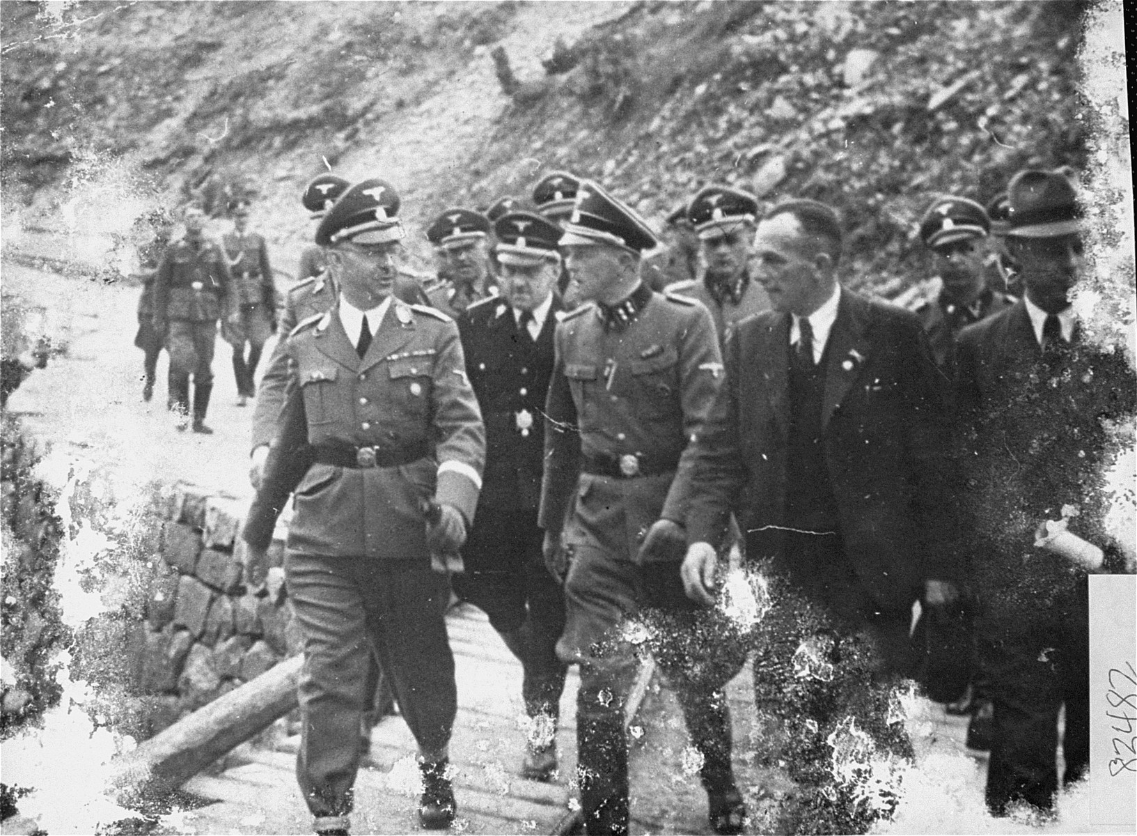 Reichsfuehrer SS Heinrich Himmler and his entourage inspect the Wiener Graben quarry during an official tour of the Mauthausen concentration camp.

Pictured in front from left to right are: Heinrich Himmler,  August Eigruber and Franz Ziereis.  Visible between and behind Himmler and Eigruber is Oswald Pohl.