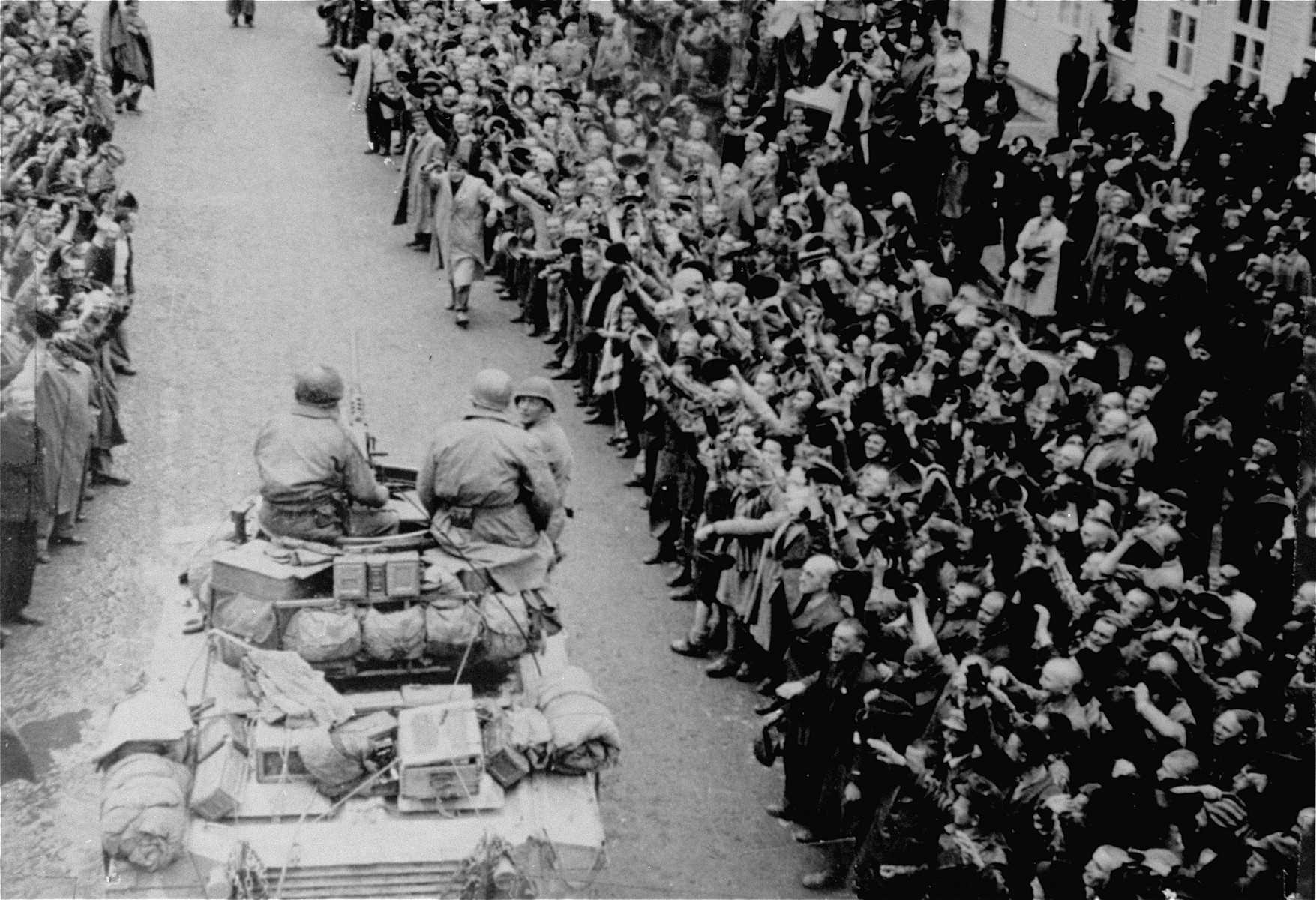 Cheering survivors greet American troops as the first Allied tanks enter the Mauthausen concentration camp.

According to P. Serge Choumoff, an historian and survivor of Mauthausen, this event was a recreation of the liberation (one day later) done at the request of General Eisenhower.