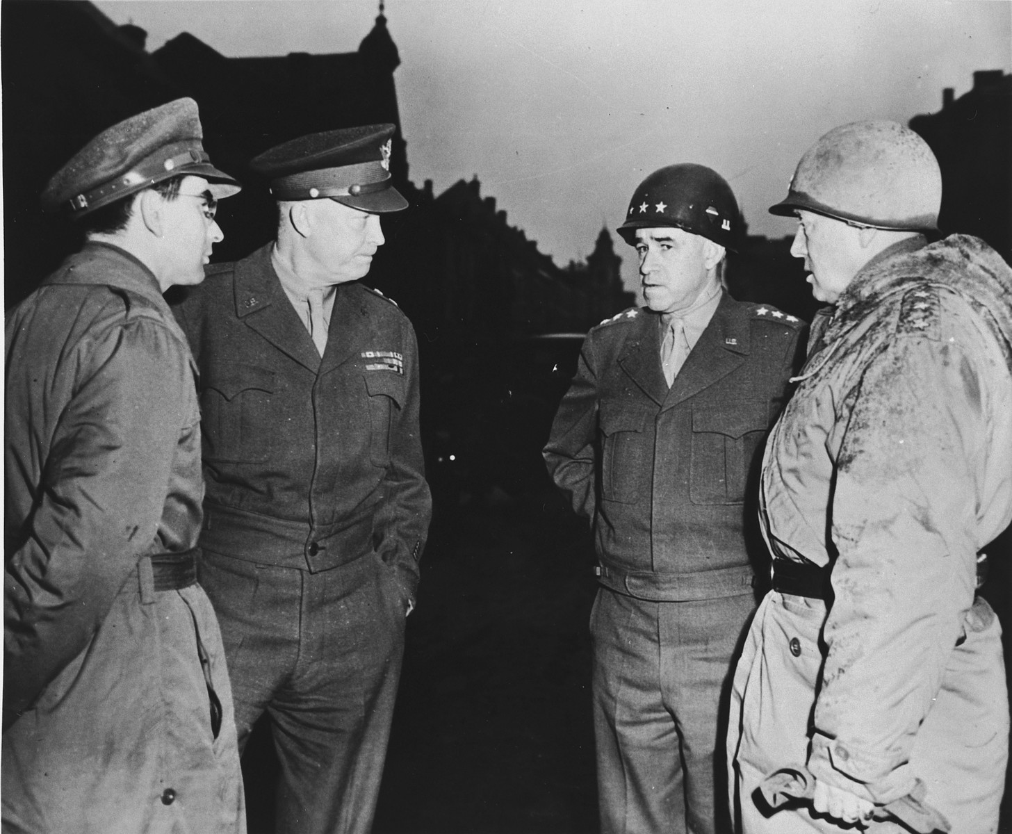 High-ranking U.S. Army officers visit the ruins of Bastogne.

From left to right are Sgt. Jules Grad, correspondent for the newspaper, "Stars and Stripes", Gen. Dwight D. Eisenhower, Lt. Gen. Omar K. Bradley and Lt. Gen. George S. Patton.
