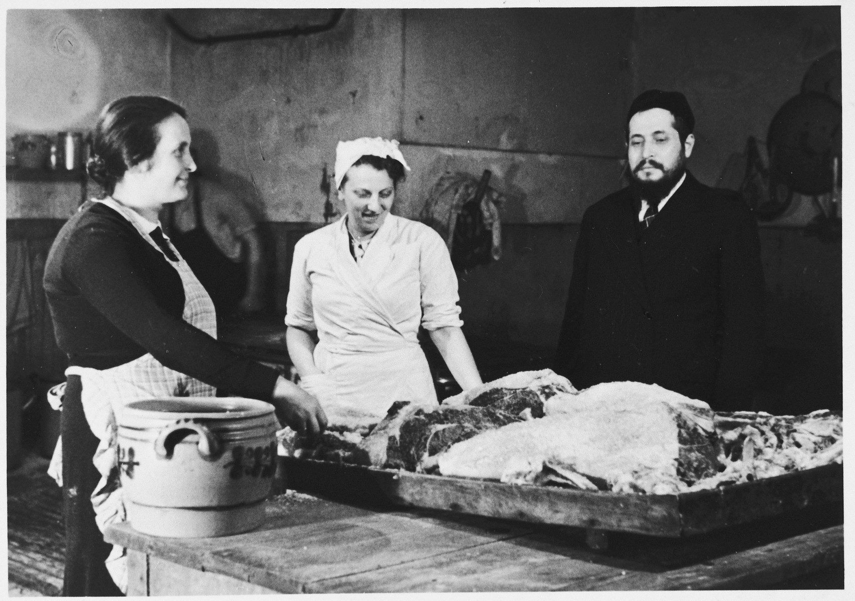 Cooks prepare a meal for Jewish refugees from the Third Reich at a refugee center sponsored by the ESRA Jewish social welfare organization.