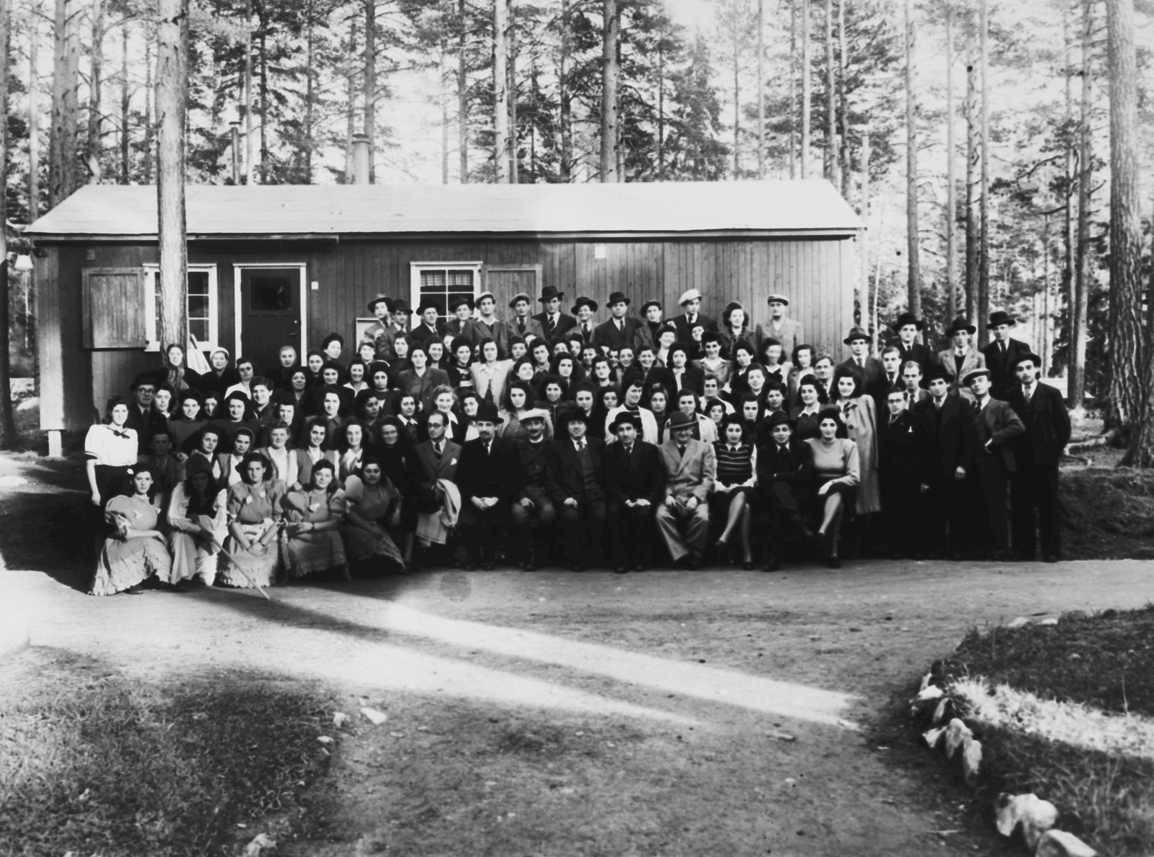 Group portrait of religious Jewish displaced persons in Sweden.

Regina Pollack is pictured in the third row, second from the right.
