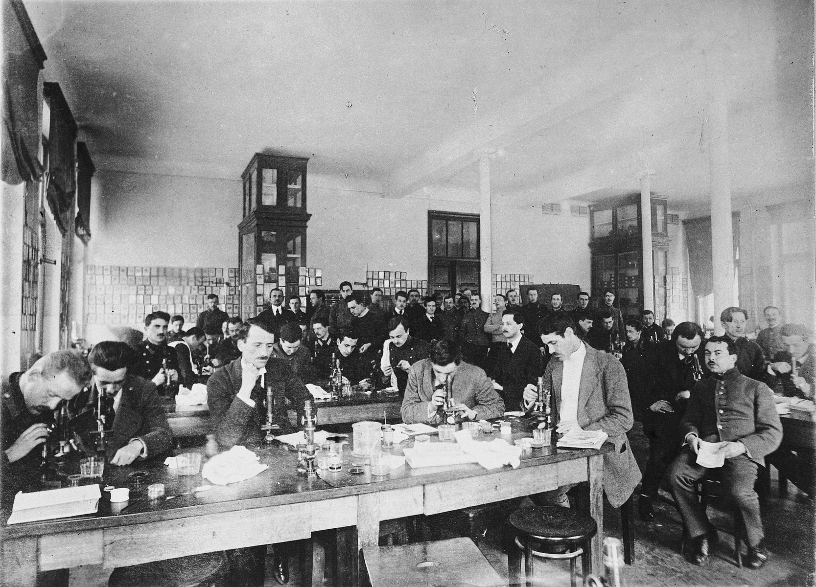 Medical students gather around tables and examine specimens under microscopes.

Among those pictured is Itzchak Rafes.