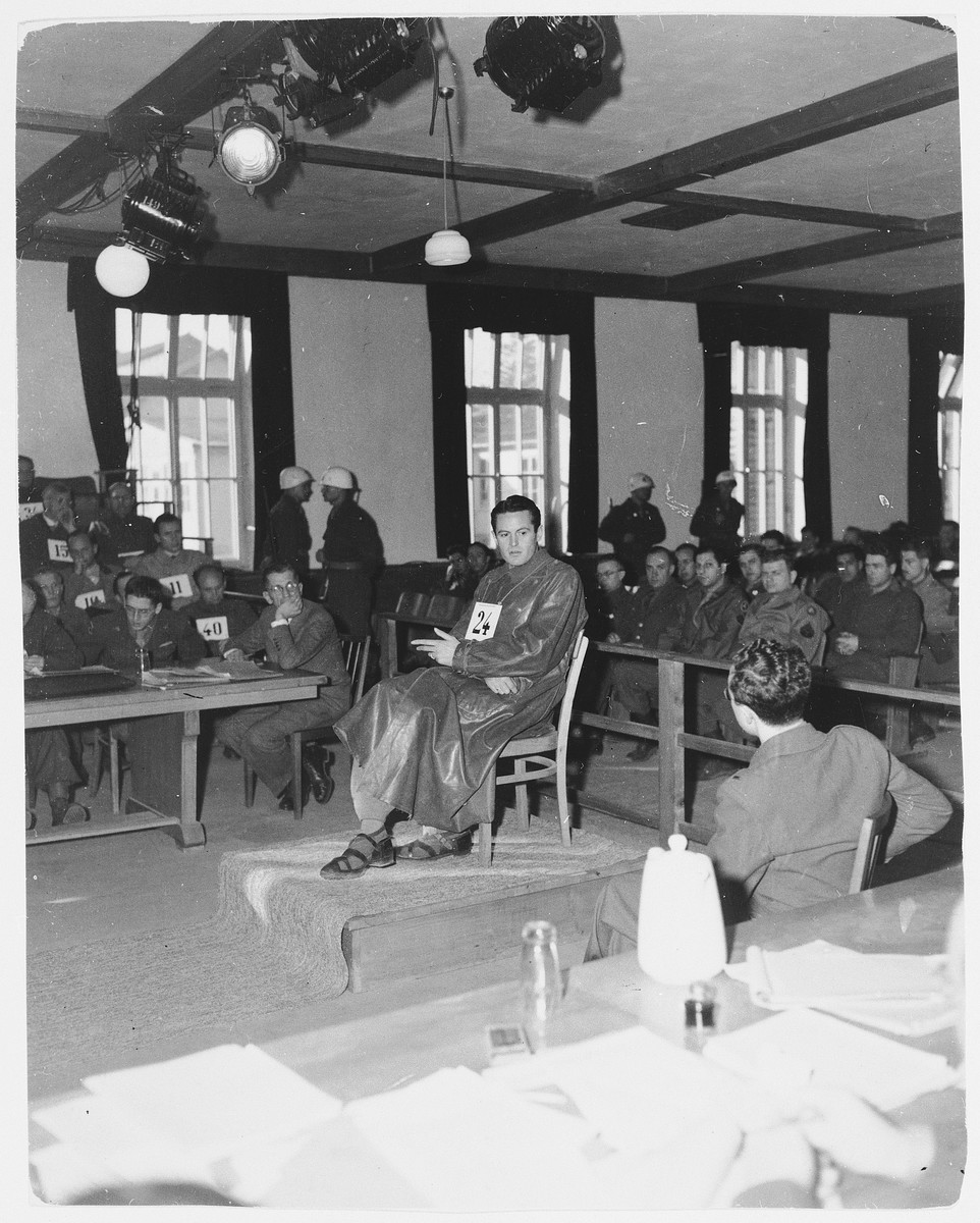 Defendant Rudolf Heinrich Suttrop takes the stand in the Dachau trial.  

Rudolf Heinrich Suttrop (b. 7/17/11) was an SS Obersturmfuehrer.  He served as an adjutant in the Dachau concentration camp from 1942-1944.  He was convicted and hanged on May 28, 1946.