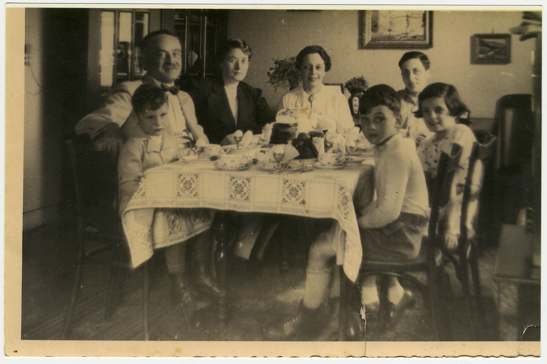 A German-Jewish father and his two sons visit with Belgium relatives.

Pictured in the left front are Manfred and Alfred Manasse.  Opposite them is Gustav Manasse.