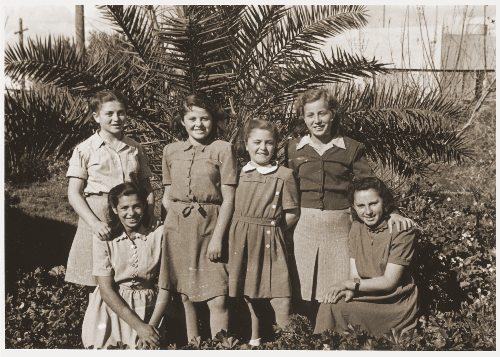 Group portrait of former Transnistria orphans, now settled in Palestine due in part to the efforts of Anny Andermann.

The inscription on the back of the photo reads: "A souvenir; the time passes quickly, the days follow each other, we write to you a souvenir because we don't know how long we will live, and as a sign of our love for you.  Anutza, Dora, Shana, Sarina, Gisella.  May God repay you, dear and good Mrs. Andermann."