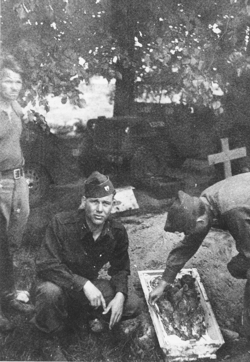 American soldiers examine the exhumed remains of the Polish and Soviet infants who died in the nursery in Ruehen.