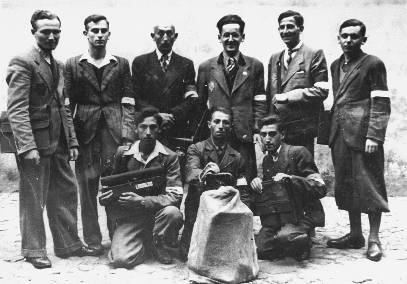 Group portrait of employees in the Lodz ghetto post office.  

Among those pictured is Nachman Zonabend (standing second from the right).