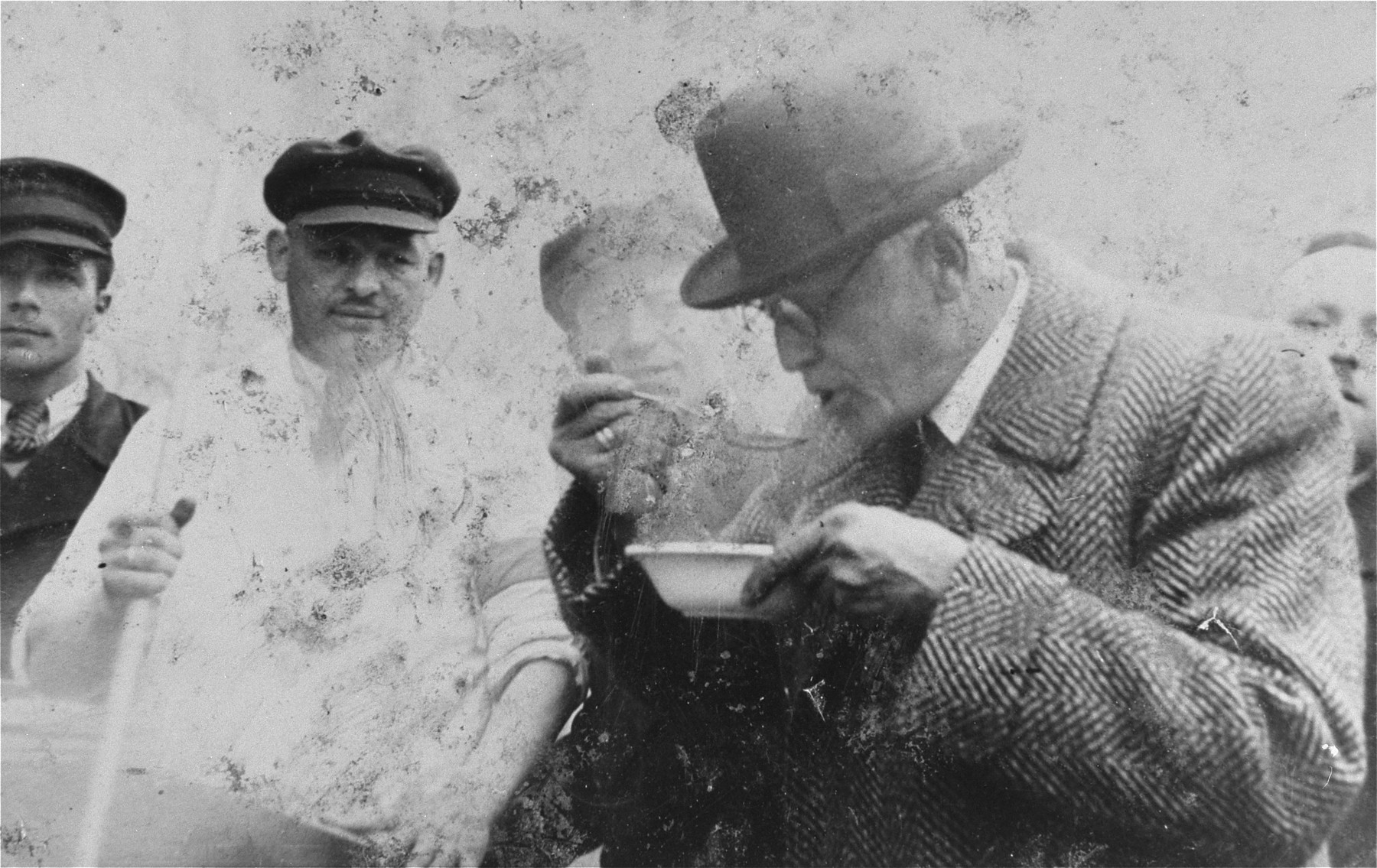 Jewish council chairman Mordechai Chaim Rumkowski, eats a bowl of soup [probably at a newly opened soup kitchen] in the Lodz ghetto.