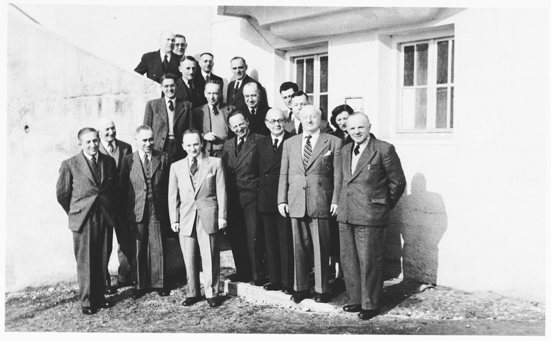 Group portrait of members of the Jewish Restitution Successor Organization (JRSO) at a staff conference in Nuremberg, Germany.

Benjamin Ferencz, the director of the JRSO, stands at the front in the lighter jacket. Also pictured is Dr. Arthur Barczinski (later Arthur Barry), in the second row, third from the left.