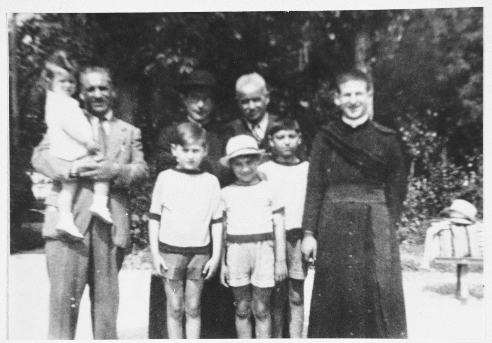 A Jewish family poses with a priest from the parish that hid them a few years later.

From left to right are Nathan Orvieto in the arms of his father, Enrico Orvieto (donor's uncle), Emanuele Pacifici, Guiliano Orvieto, Gualtiero Orvieto, and the priest whose name is unknown.  Behind them is Don Gaetano Tantalo and Mario Pacifici (the donor's paternal grandfather).

Don Gaetano Tantalo hid all nine members of the Ovieto family for approximately nine months.  He passed away a few months after the end of the war but in 1978 was recognized as Righteous Among the Nations.