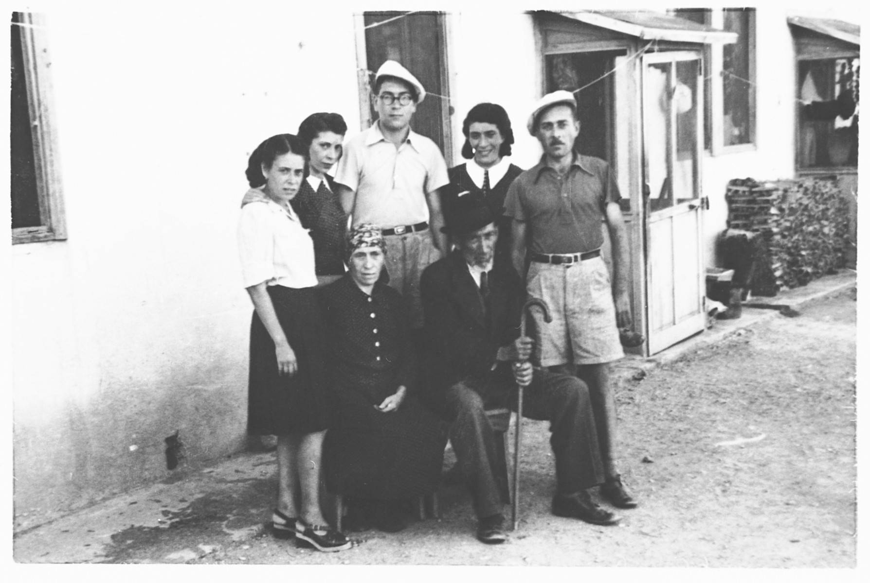 Group portrait of the Ermanno Stern family, internees in the Ferramonti camp.

This photograph was taken during a visit by Rabbi Riccardo Pacifici.