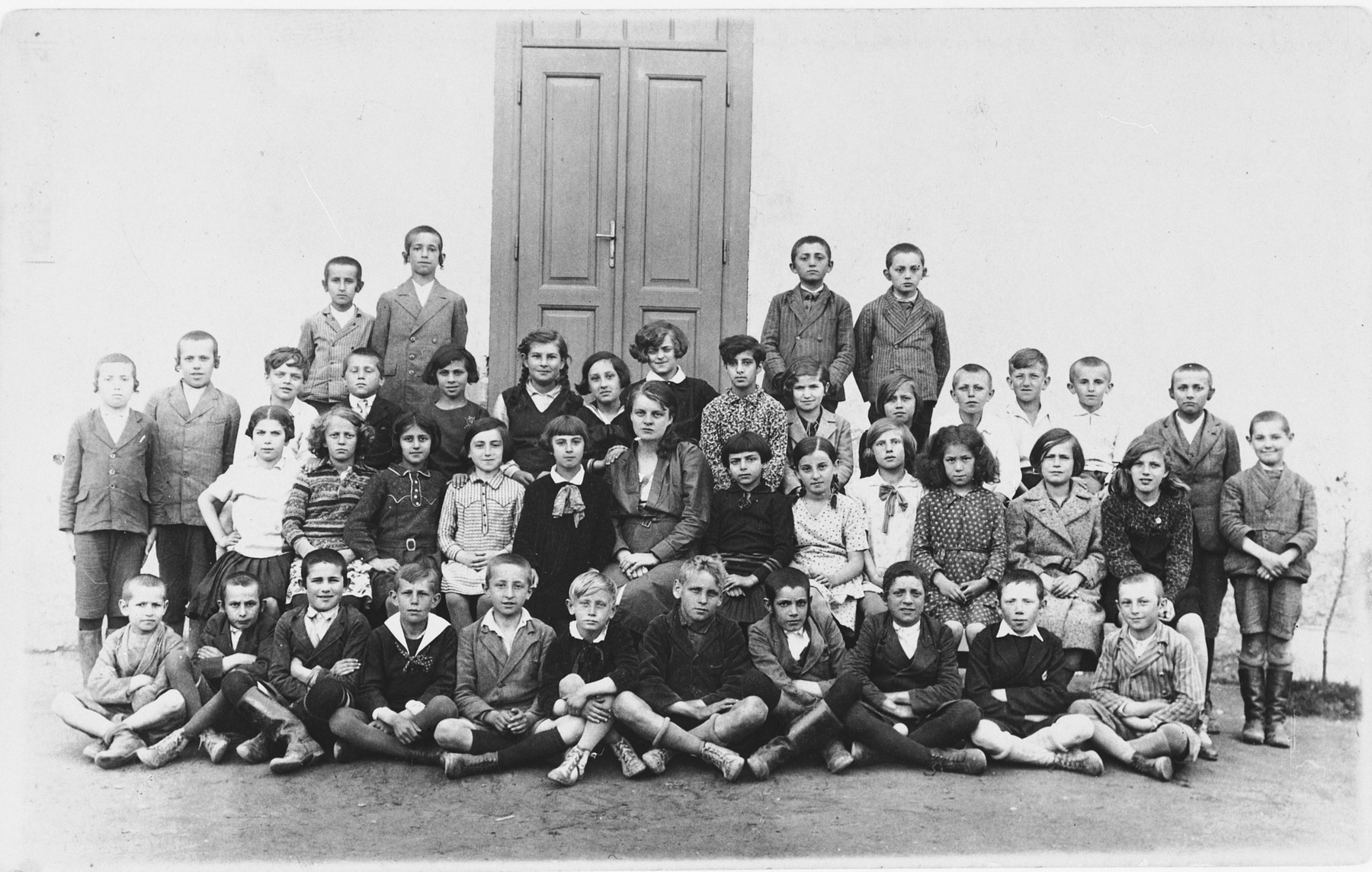 Group portrait of Jewish and non-Jewish children in a public school in Tacovo.

Among those pictured is Goldie Berger.