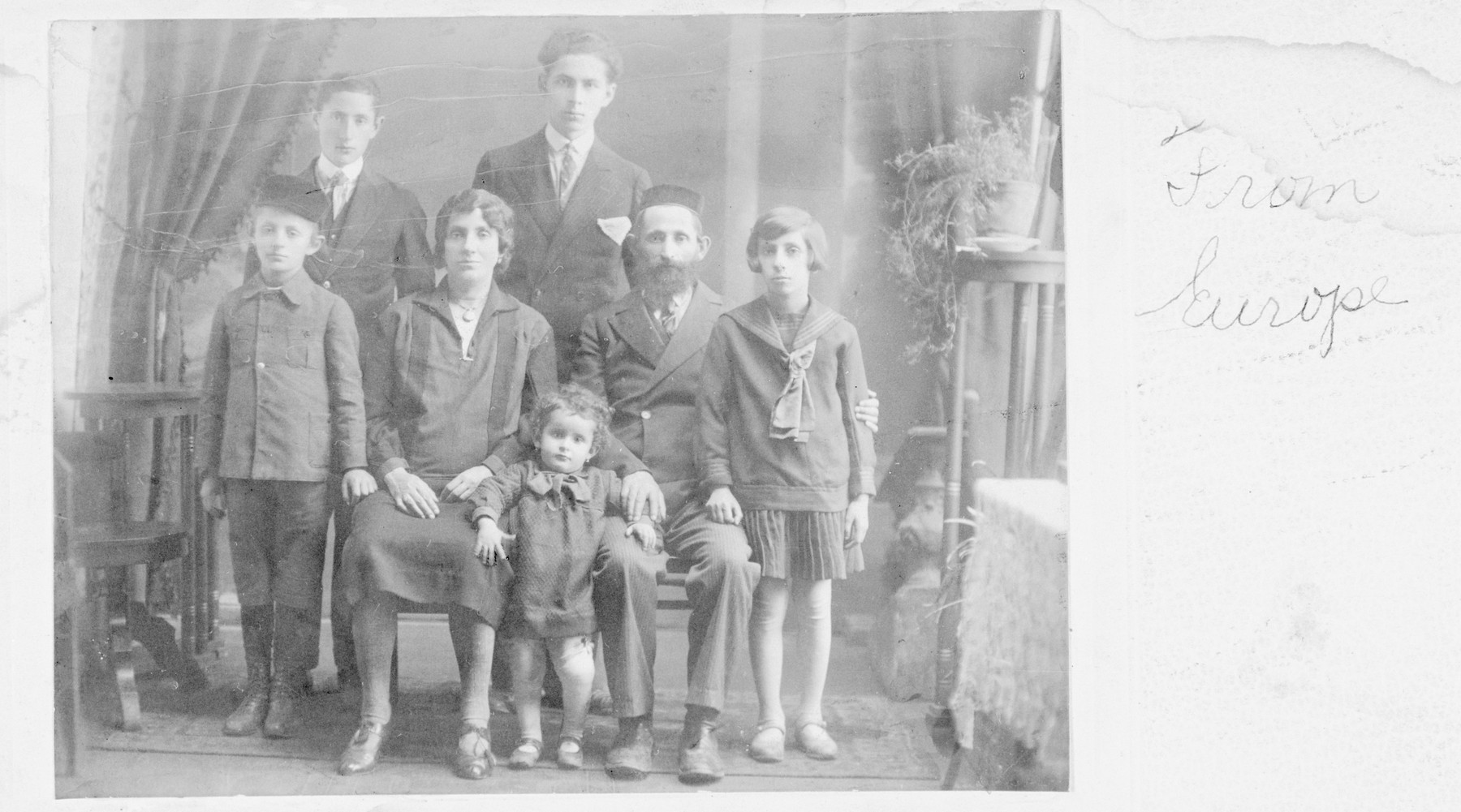 Studio portrait of Fraidl and Yehoshua Weinstein and their five children in prewar Poland.

Moshe Herschel is standing at the lower left.  The young child, Raizl, stands next to Yehoshua (Osias) Weinstein, and Miriam stands at the far right.  At the top right, stands Joseph, the oldest son.  None of the family members survived.