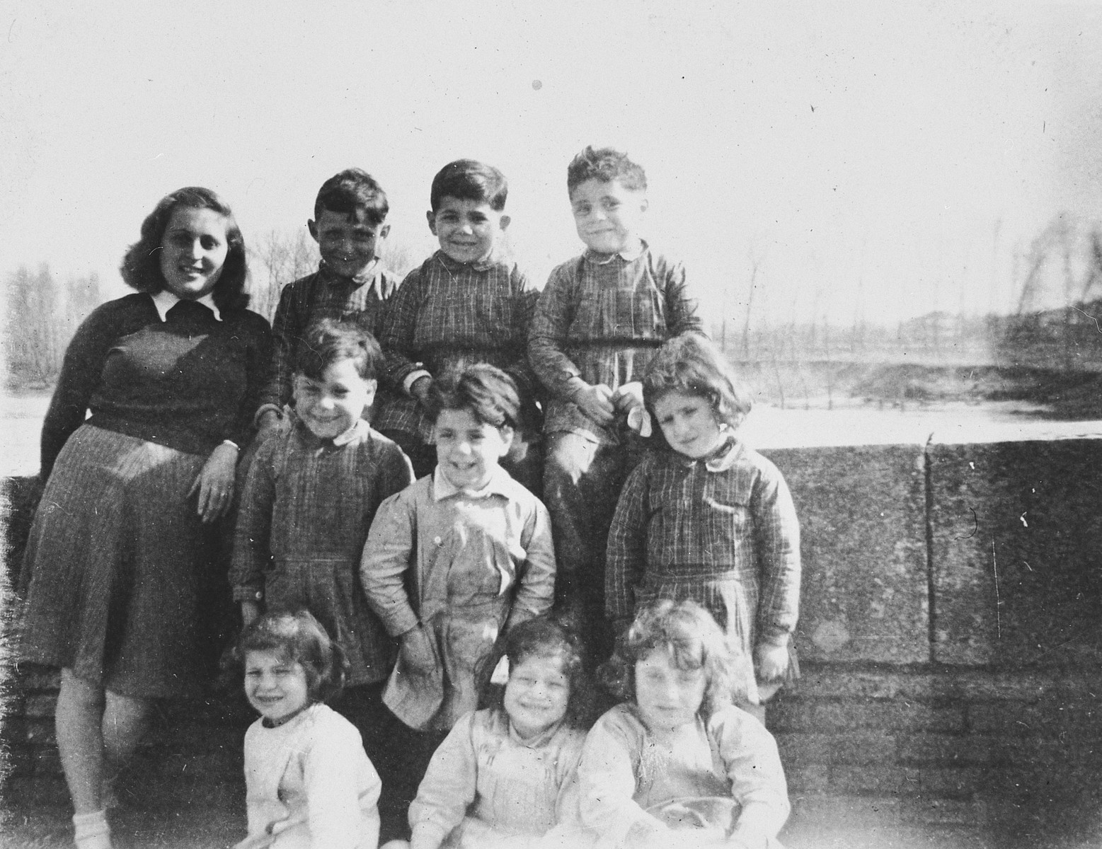 A Jewish teenager poses for a group portrait with the young children she is helping teach the alphabet to in Vic-sur-Cere.

Pictured standing on the left is the donor, Ruth Strauss.
