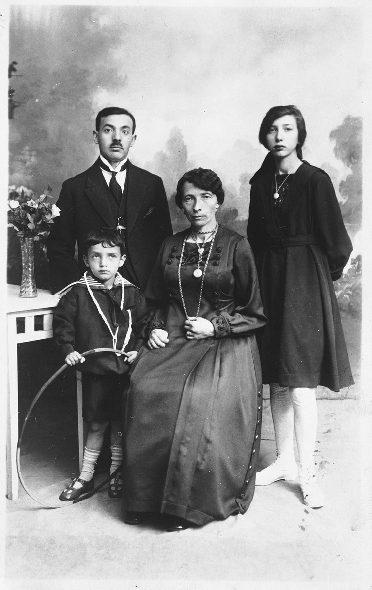 Studio portrait of a Jewish family in Copenhagen.

Pictured are Nachmendel and Esther Malka Lystmann and their two children.  The daughter is names Sara Bela.  The Lystmanns were cousins of the Diament family.