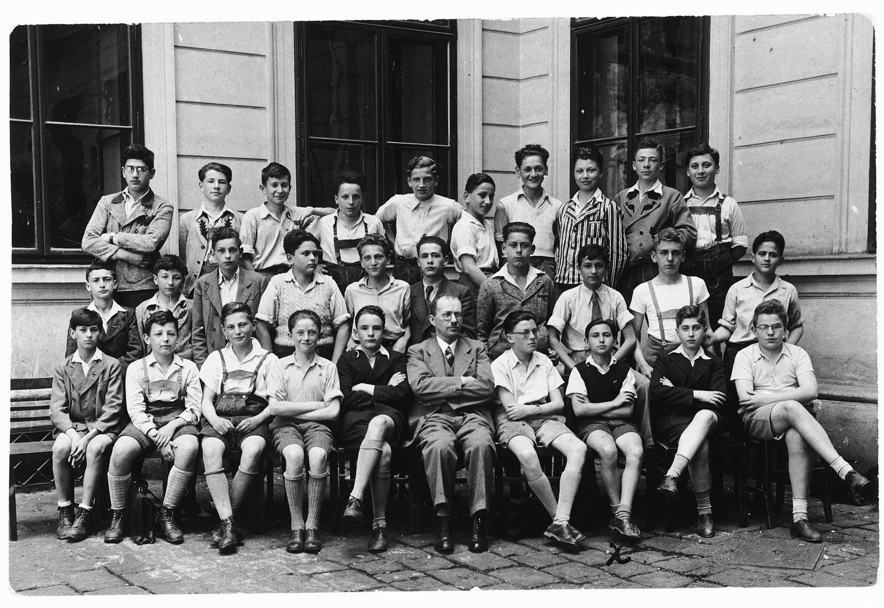 Portrait of a high school class in Vienna composed almost exclusively of Jewish children.

Heinrich Wellisch is seated in the front row, third from the right.