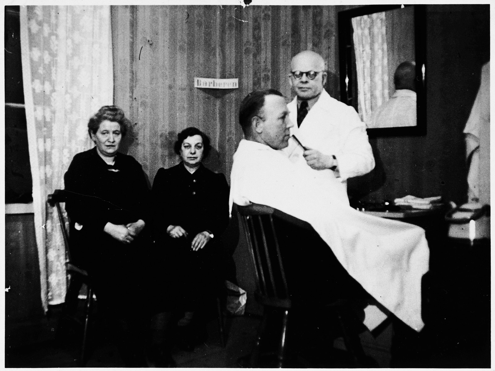A Jewish refugee from Denmark, who was ferried to Sweden during the Danish rescue operation in October 1943, works at his own barbershop in Sweden.
