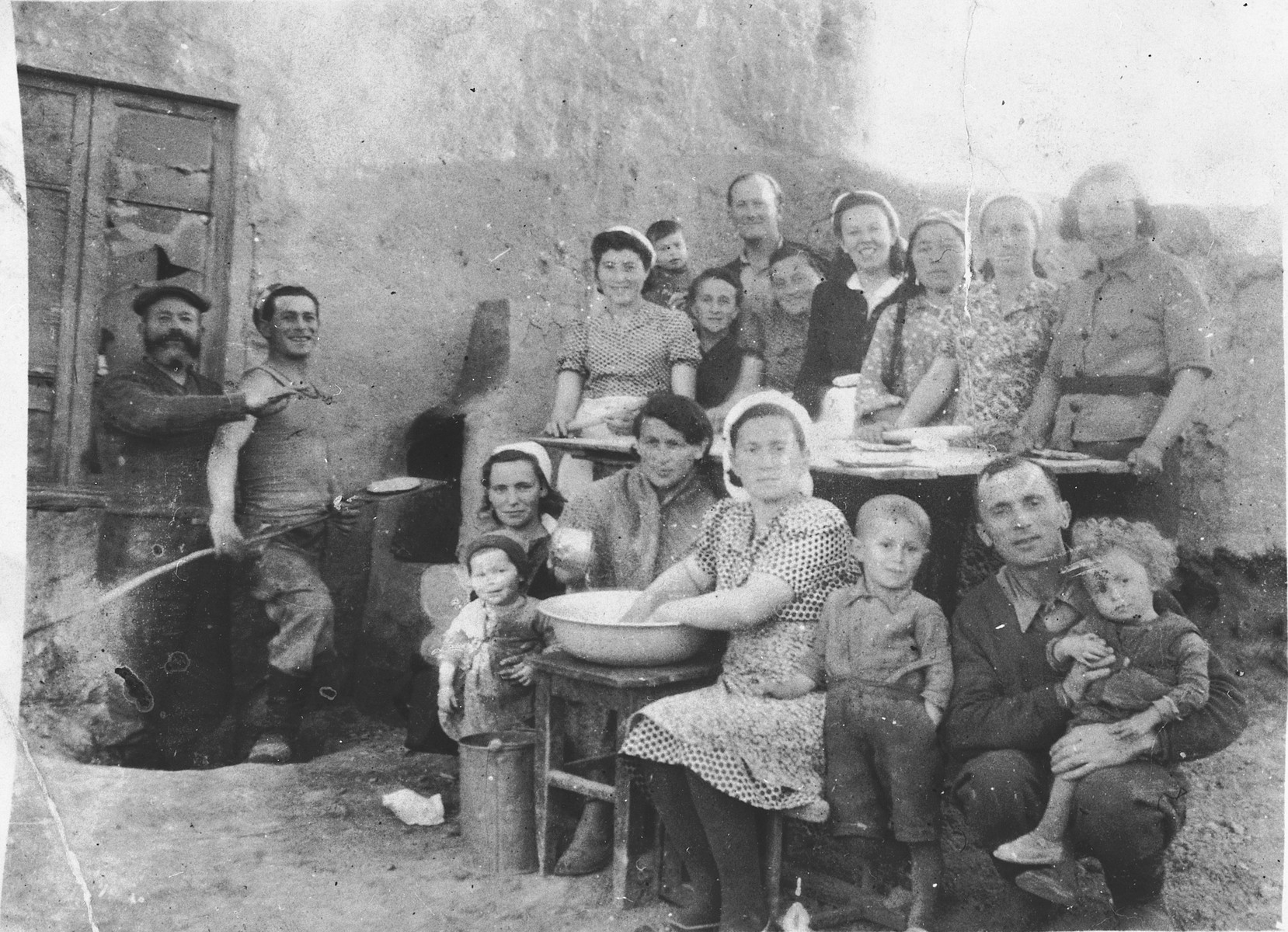 Polish Jews refugees who spent World War II in the Soviet interior, bake matzah for the Passover holiday.

Among those pictured are Joseph Bankir (top row, next to the boy), Israel Bankir (top row, the little boy), Pola Bankir (second row from the top, left), Mojzesz Szczukowski (second from the left, holding the shovel), Hela (Krakower) Szczukowski (front row, left, holding the child, Malka Szczukowski).