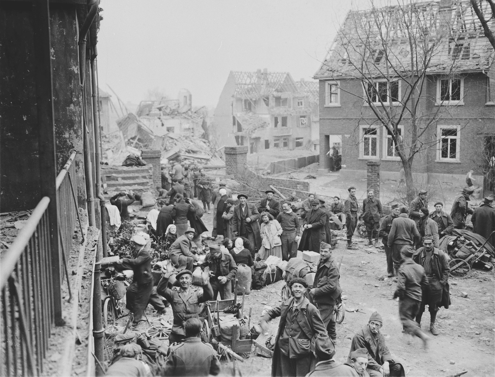 Slave laborers in the town of Altenkirchen, who were liberated by the U.S. First Army, collect their belongings and await evacuation to a nearby area.