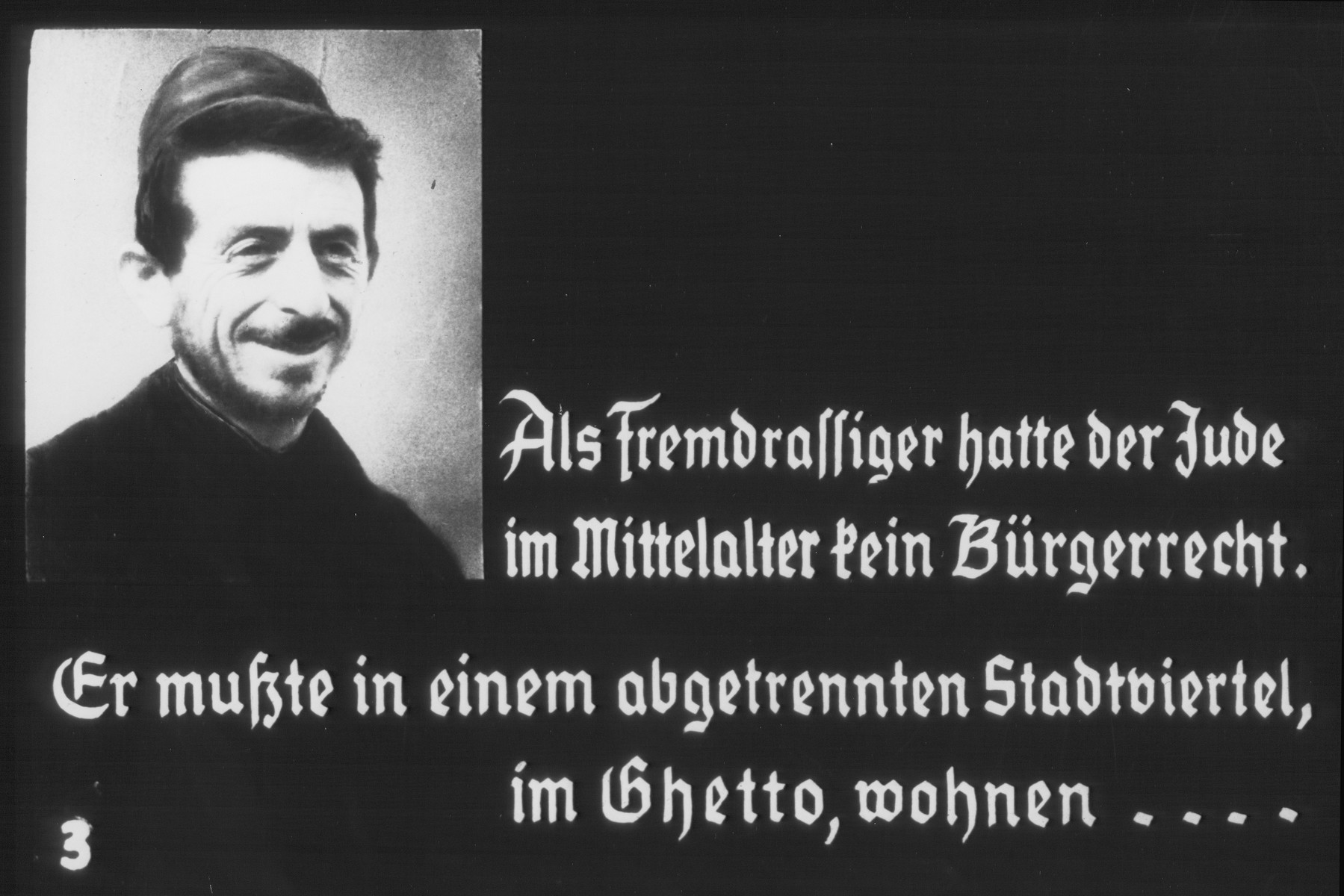 Propaganda slide entitled "As a member of a foreign race, the Jew in the Middle Ages had no rights of citizenship.  He had to live in a ghetto in a separate quarter of the town..."
