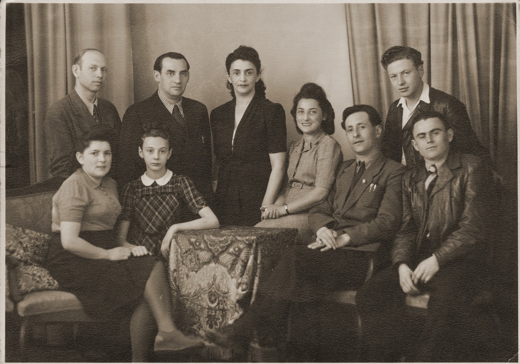 Group portrait off Jewish DPs living in the city of Bayreuth.

Among those pictured standing are Feliz Kozywoda (William's uncle, second from the left) and Welek Luksenburg (right).  Seated (second from the left, the daughter of Moniek Merin) is Helinka Merin, standing in the center is Maryska Gancwiach (the first wife of Moniek Merin).