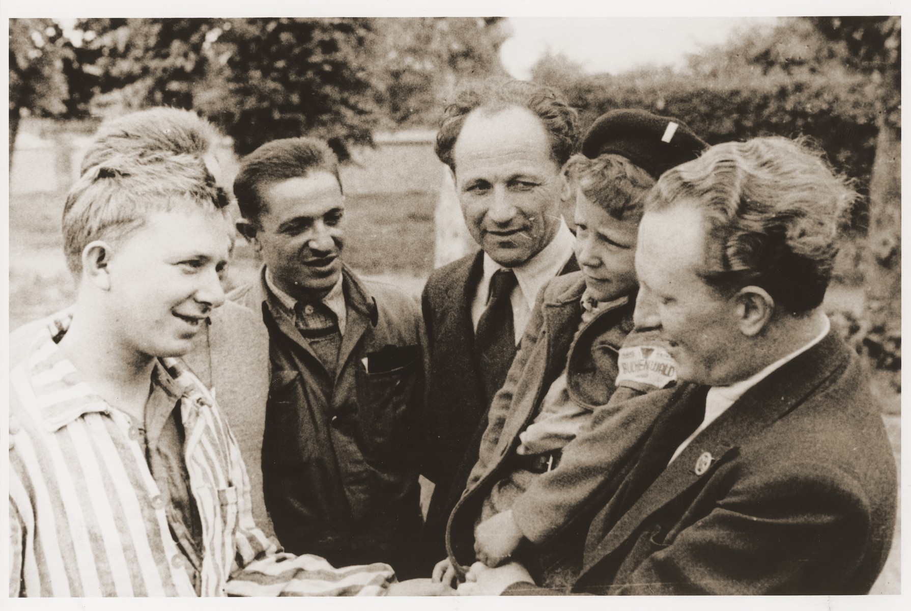 OSE (Oeuvre de Secours aux Enfants) officials meet with members of the Buchenwald children's transport at the OSE home in Ecouis.

Pictured second from the right is Yisrael Meir (Lulek) Lau.  On the far right is Joseph Fisera, the head of the MACE.