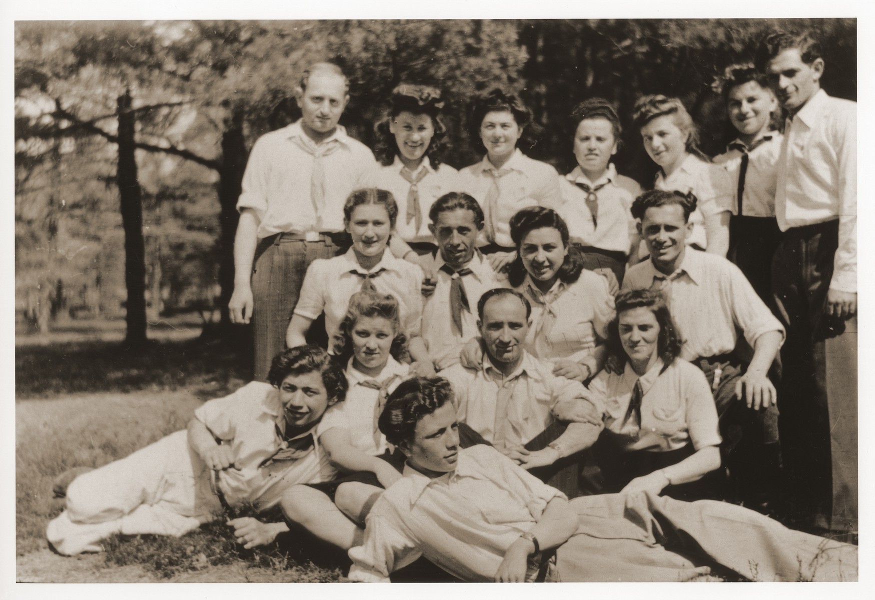 Group portrait of members of Kibbutz Nocham in the Bergen-Belsen displaced persons camp.

Szaja Aron Knobler (now Alex Knobler) is the son of Moszek and Jocheta Knobler.  He was born in 1921 in Bedzin, Poland.  Szaja had three older sisters, Ita, Esther and Leah.  In 1931 the family moved to Chorzow near the German border.  There Szaja became active in the Akiba Zionist youth movement.  In 1938 he joined the Akiba hachshara [agricultural training farm] in Bielsko and made plans to immigrate to Palestine.  His plans were thwarted, however, by the start of World War II.  In the first months of the war Szaja fled to the Soviet sector of Poland, where he explored possible exit routes to Palestine via Romania for the nascent Zionist underground.  During a visit home in 1940 Szaja was caught up in the forced resettlement of his family to the Sosnowiec ghetto.  From Sosnowiec Szaja was deported to the Blechhammer labor camp, where he remained until the camp was evacuated in January 1945.  During the forced march out of the camp Szaja ran away with two friends.  German guards shot and killed his friends but Szaja escaped.  Posing as a Polish laborer, Szaja found refuge with a German farmer in Gleiwitz until liberation.  After the war Szaja, who was the sole survivor of his immediate family, took a leading role in the setting up of Zionist collectives in Poland.  He also was active in the Bricha and Aliyah Bet [illegal immigration to Palestine] movement.  This activity led to his arrest in Sosnowiec by the NKVD.  Following his release from prison, Szaja left Poland for Germany.  During the summer of 1945 Szaja organized Zionist activities at the Foehrenwald displaced persons camp.  In October he moved on to the Bergen-Belsen DP camp, where he joined a group of 400 would-be immigrants to Palestine.  The group sailed aboard the Tel Hai from Marseilles in March 1946.  When the ship reached Palestine, it was intercepted by the British and its passengers interned for three weeks in Athlit.  Following his release Szaja settled in Kibbutz Masada, but by December 1946 he was back in Germany.  Serving as an emissary for NOHAM (Noar Halutzi Meuchad), a Zionist youth umbrella group, Szaja distributed immigration certificates and organized Youth Aliyah groups in the DP camps.  While working at the Belsen DP camp Szaja met Pola Blicblum, a survivor from Lodz.  They were married in the Landsberg DP camp on July 30, 1947.  Soon after they settled in Palestine.